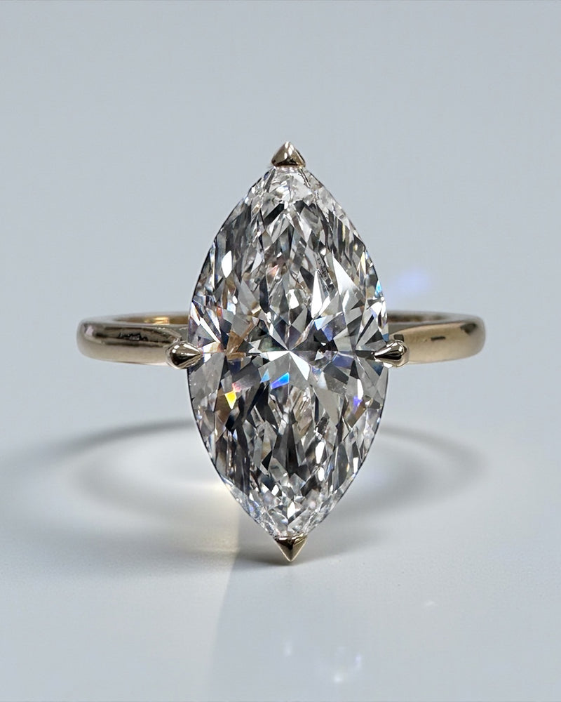 Marquise diamond solitaire ring featuring a hidden halo setting in white gold