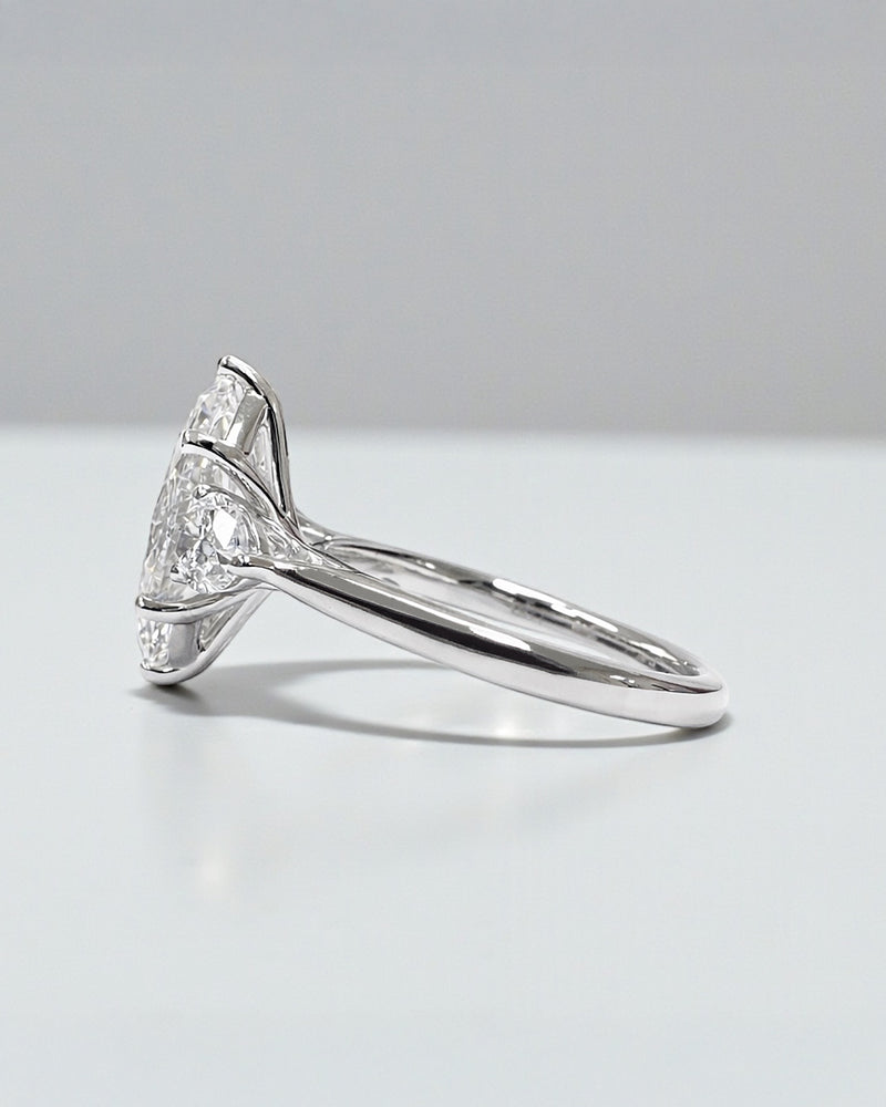 Close-up detail of a high-quality marquise diamond featuring pear side diamonds.
