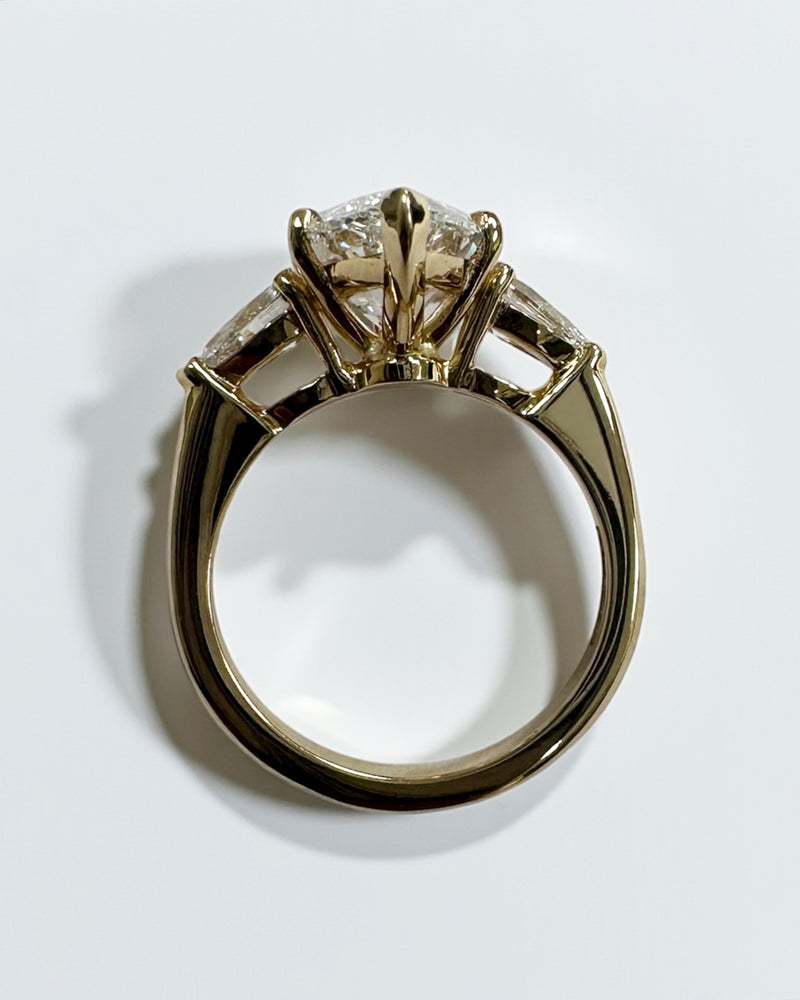 Detailed look at the setting of this 3ct marquise engagement ring diamond with pear side stones.