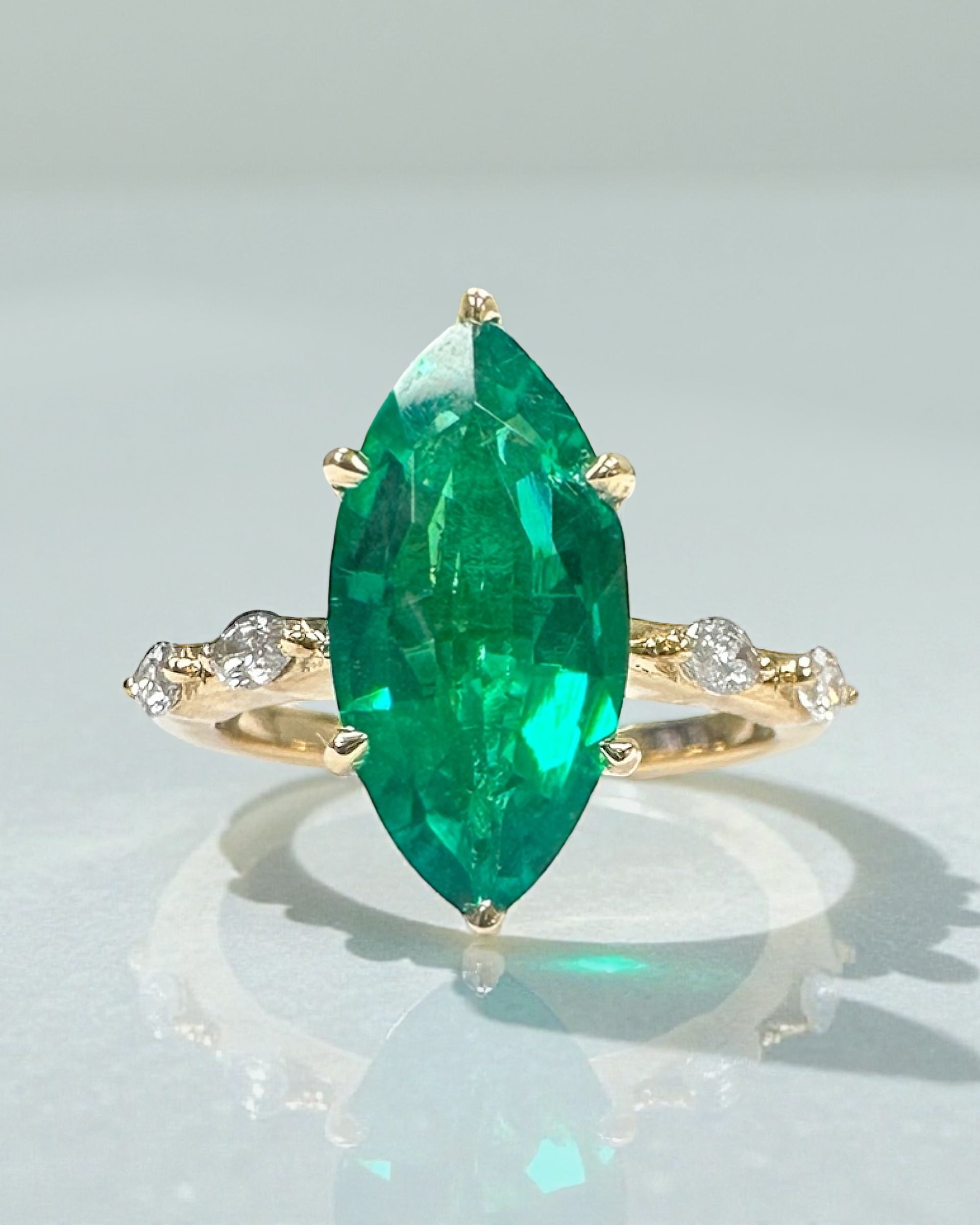 Perspective view of the unique 2.40ct green emerald marquise engagement ring.