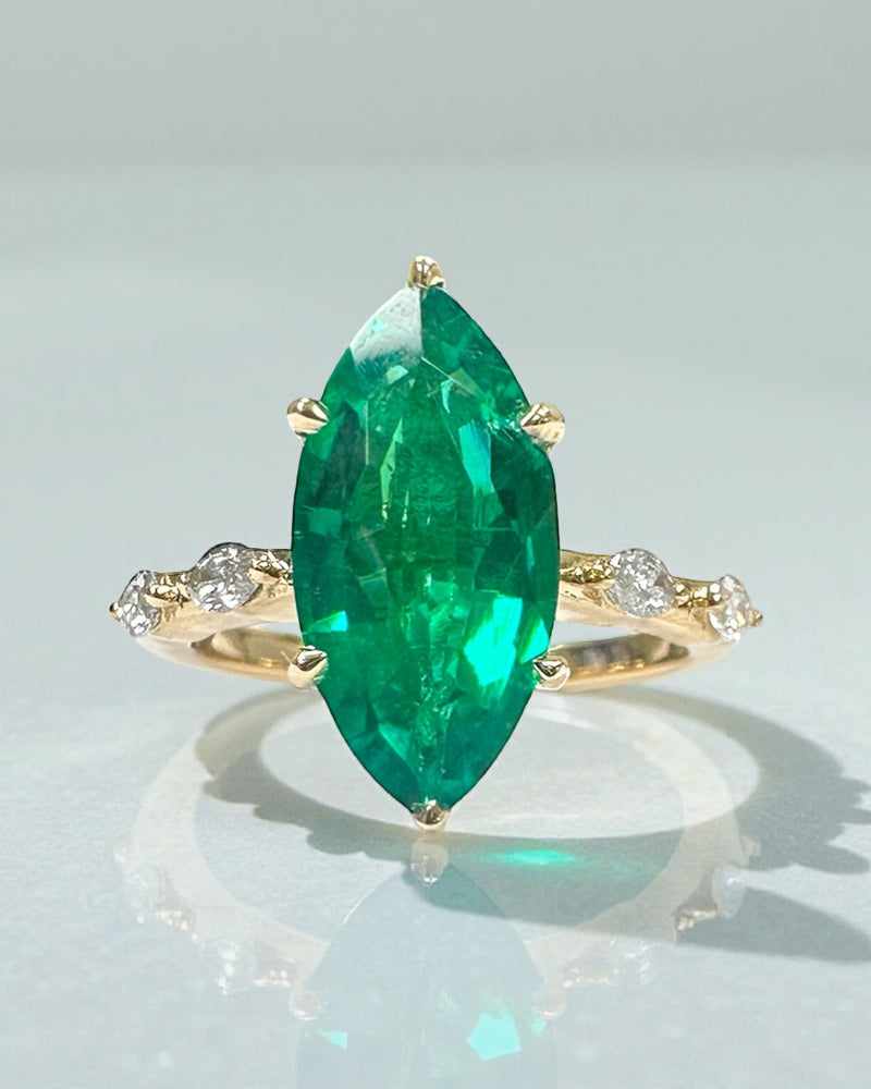 Perspective view of the unique 2.40ct green emerald marquise engagement ring.