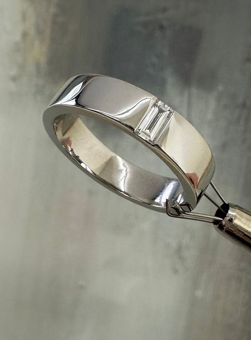 A modern 5mm flat profile ring with inset baguette diamonds from our premium men's wedding band collection.