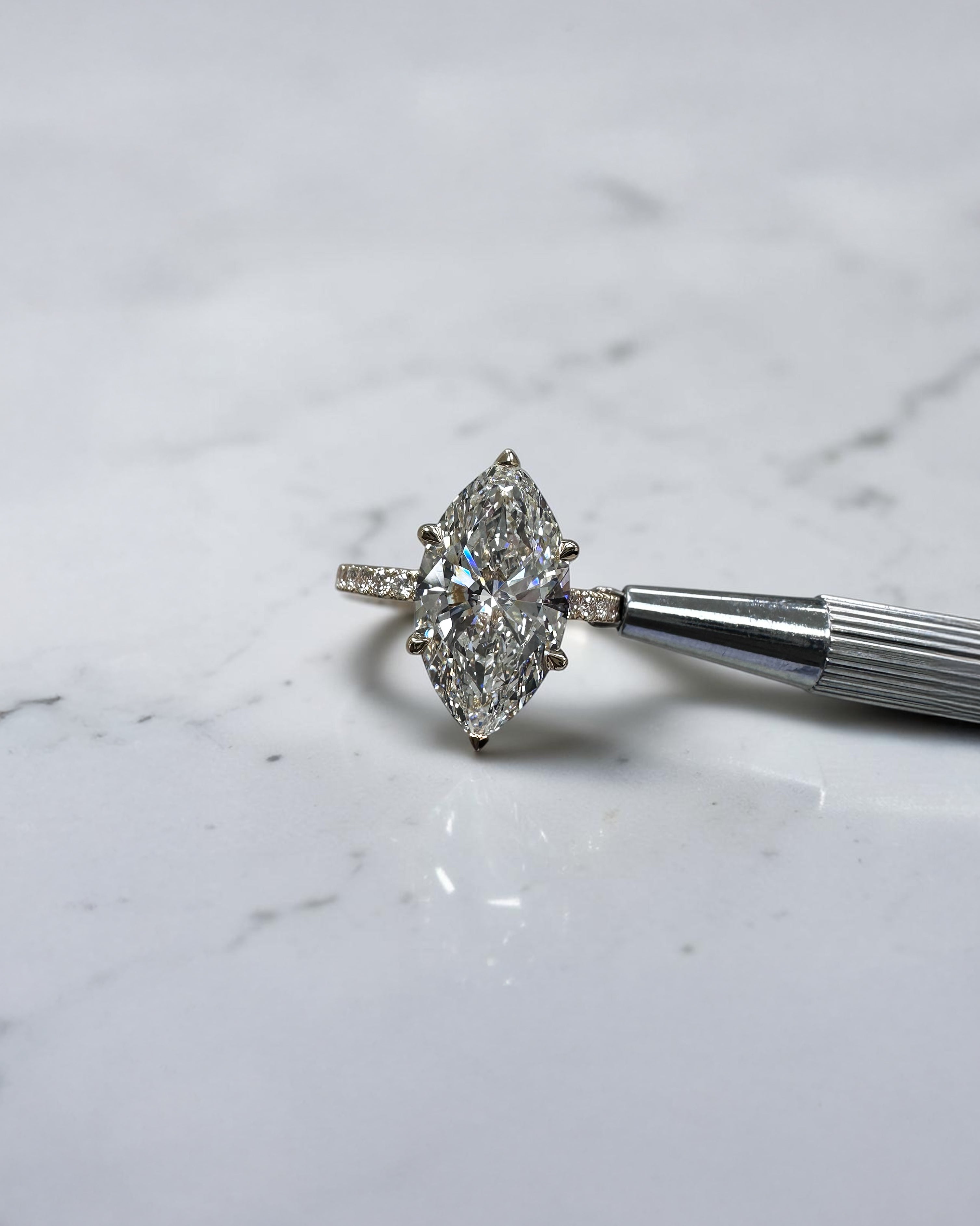 5ct marquise cut lab grown diamond engagement ring with hidden halo and diamond shoulders in floating setting