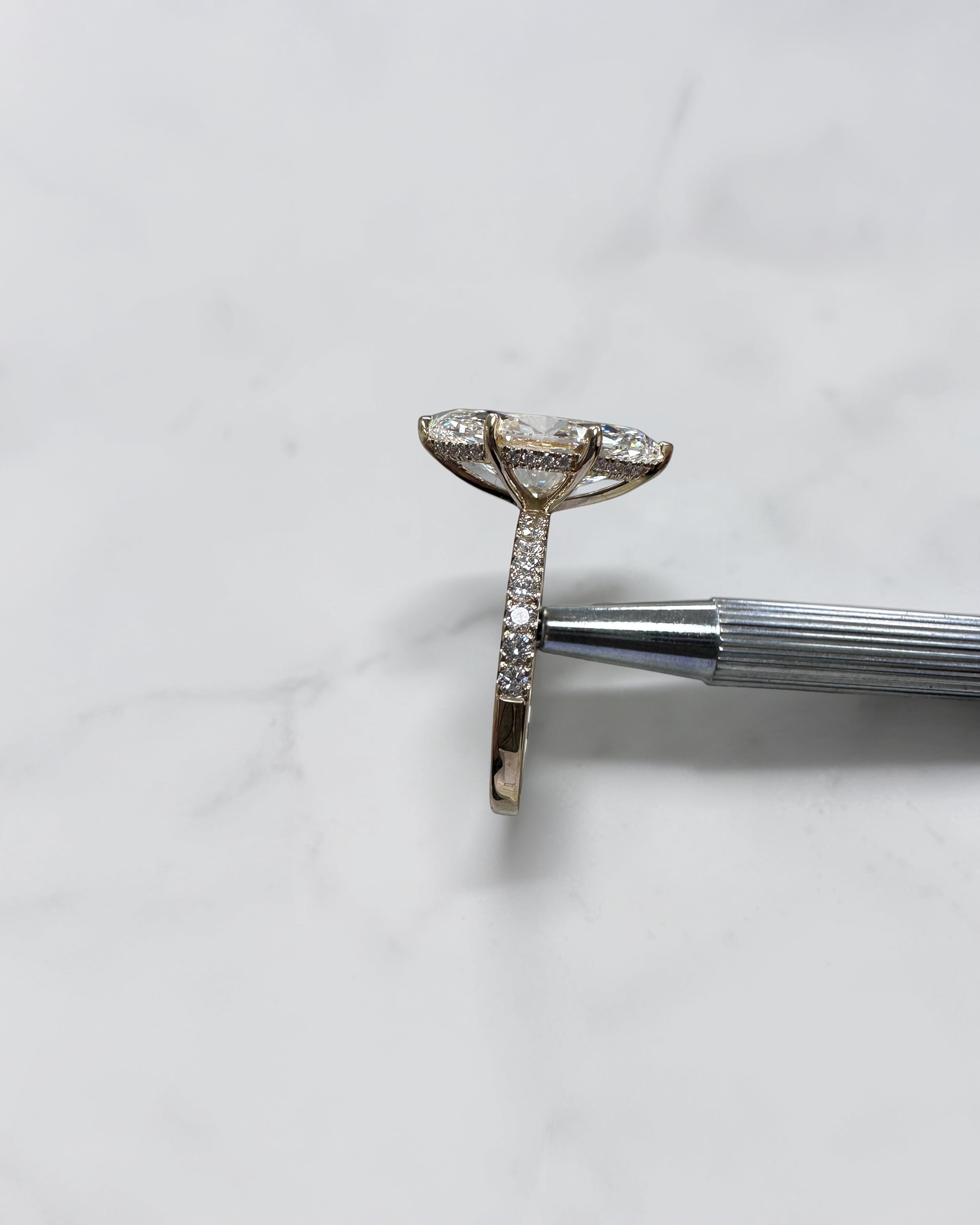 5ct marquise cut lab grown diamond engagement ring with hidden halo and diamond shoulders in floating setting