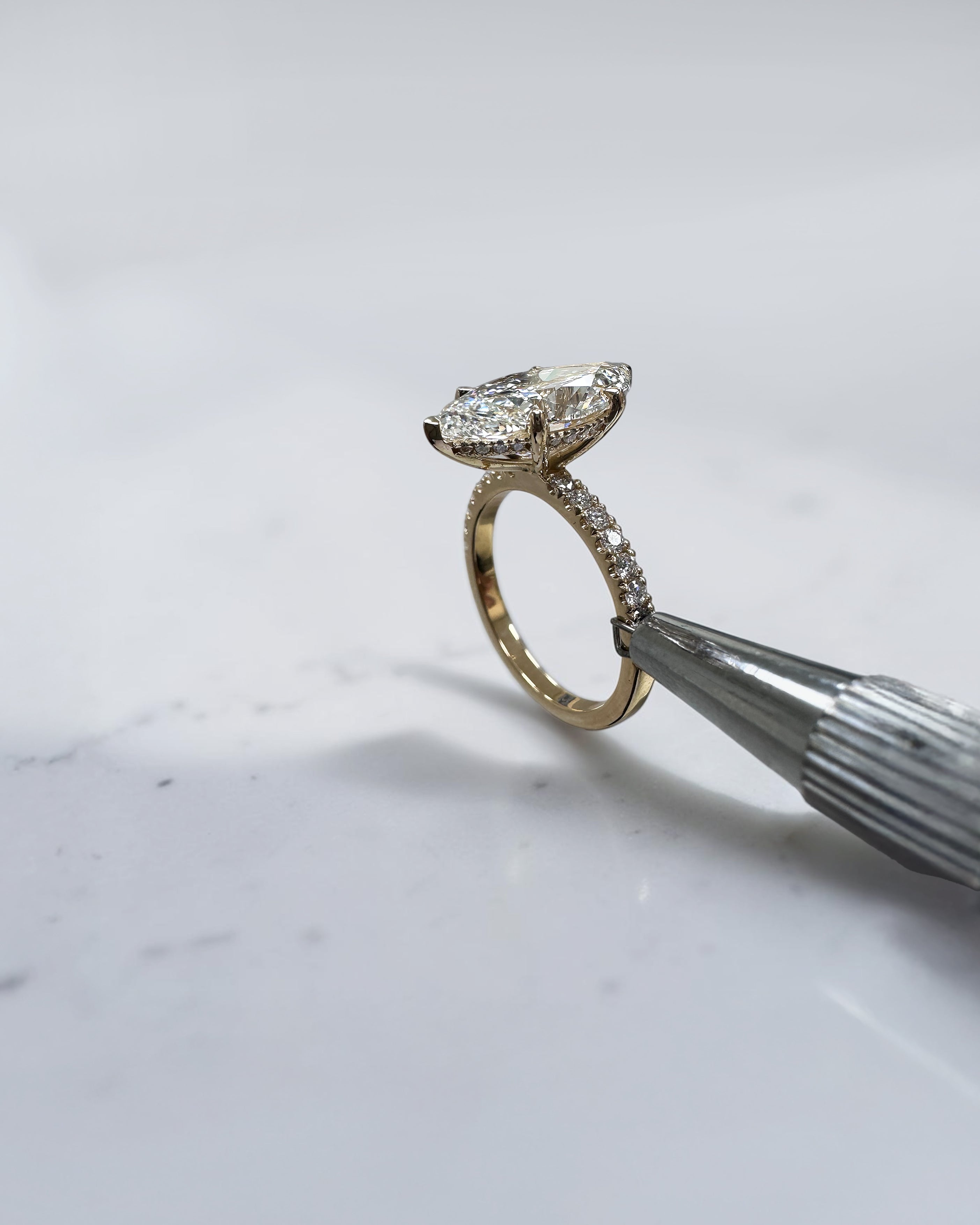 5ct marquise cut lab grown diamond engagement ring with hidden halo and diamond shoulders in floating setting