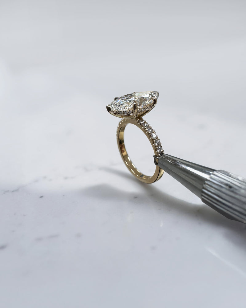 5ct marquise cut lab grown diamond engagement ring with hidden halo and diamond shoulders in floating setting