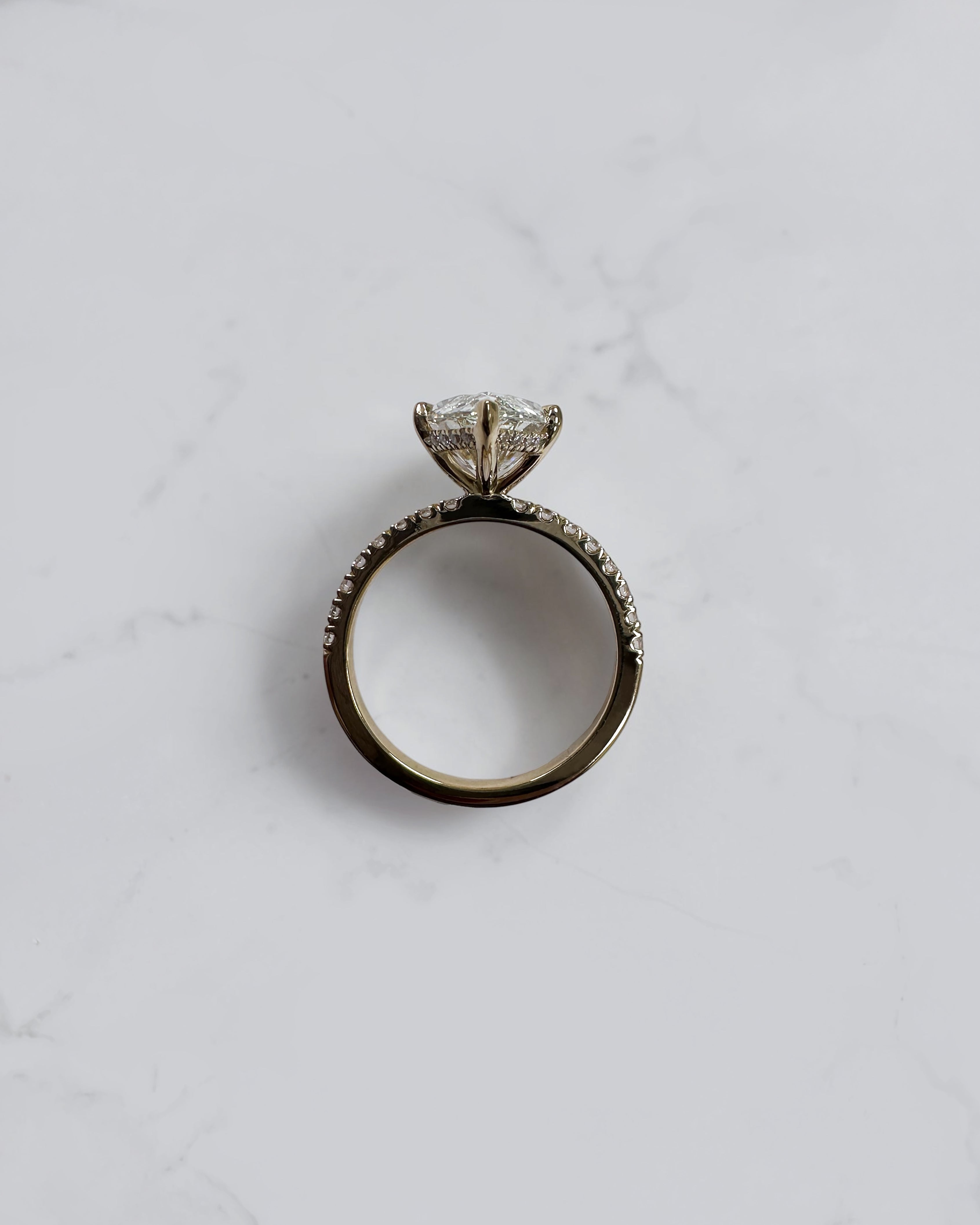 5ct marquise cut lab grown diamond engagement ring with hidden halo and diamond shoulders in floating setting