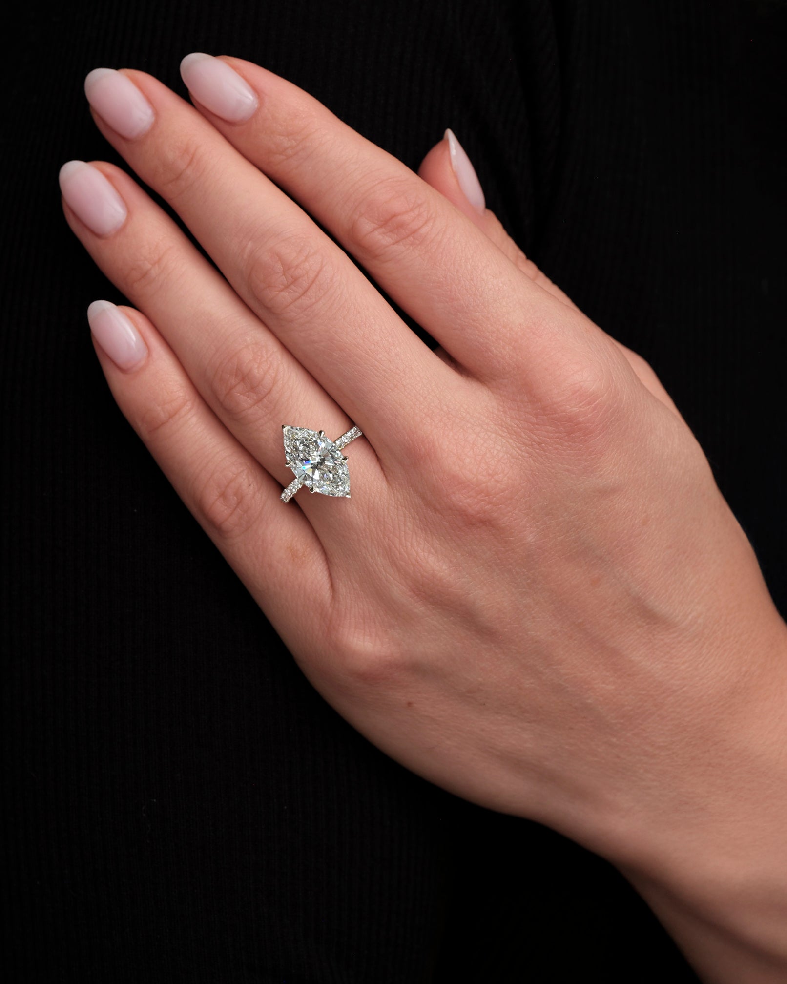 5ct marquise cut lab grown diamond engagement ring with hidden halo and diamond shoulders in floating setting on hand