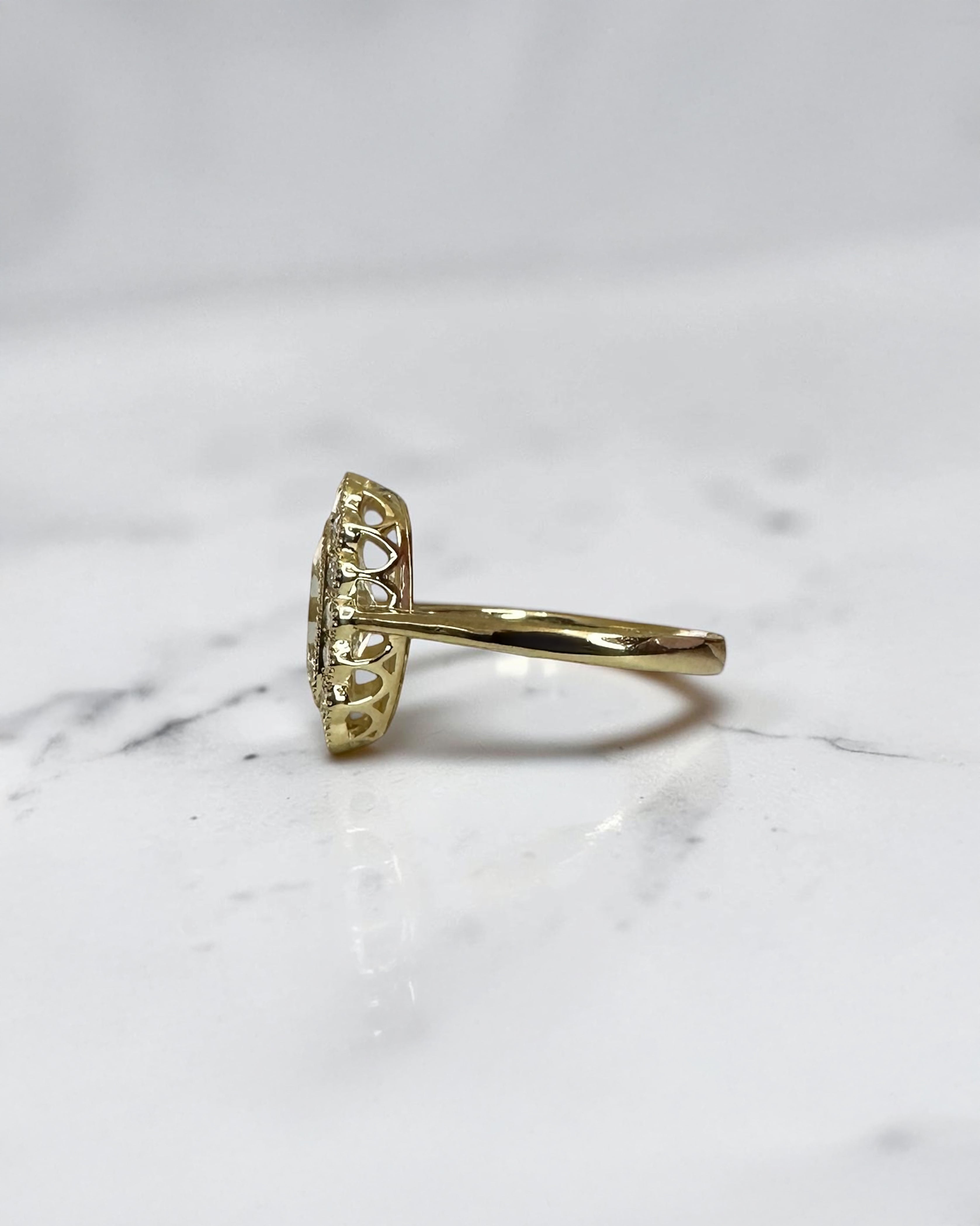 2ct elongated old mine cut cushion lab grown diamond engagement ring with bezel setting and vintage scalloped diamond halo
