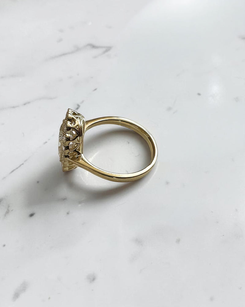 2ct elongated old mine cut cushion lab grown diamond engagement ring with bezel setting and vintage scalloped diamond halo
