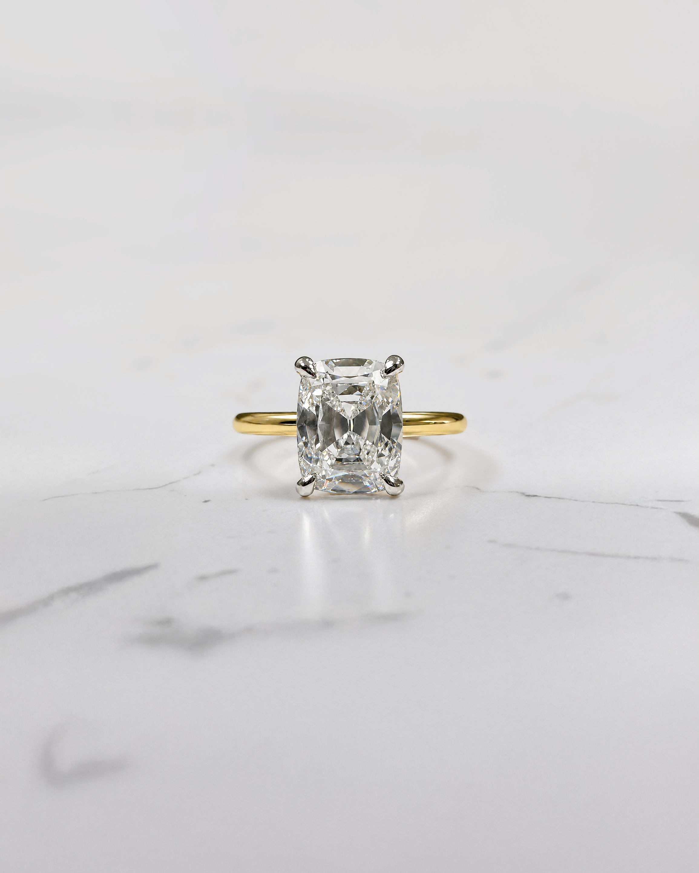 2.90ct old mine cut elongated cushion diamond engagement ring with hidden halo in two tone 18kt yellow gold band and platinum setting