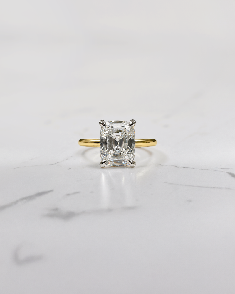 2.90ct old mine cut elongated cushion diamond engagement ring with hidden halo in two tone 18kt yellow gold band and platinum setting