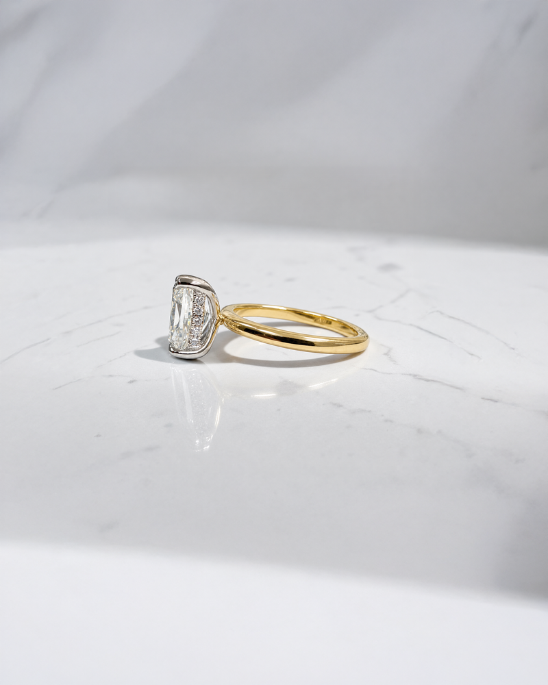 2.90ct old mine cut elongated cushion diamond engagement ring with hidden halo in two tone 18kt yellow gold band and platinum setting