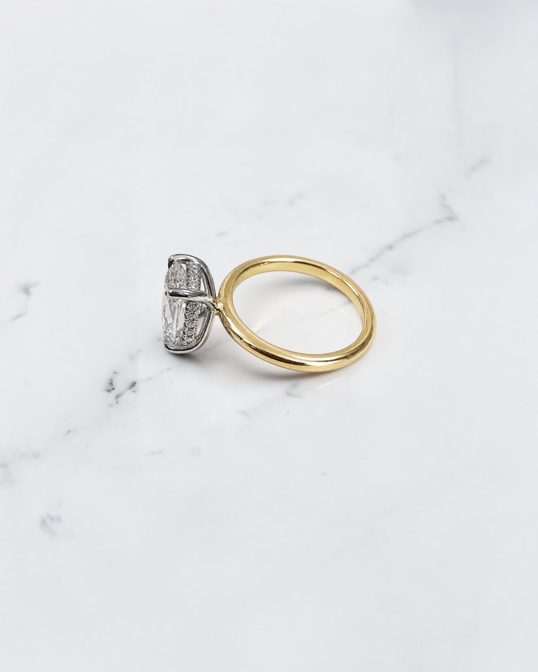 2.90ct old mine cut elongated cushion diamond engagement ring with hidden halo in two tone 18kt yellow gold band and platinum setting