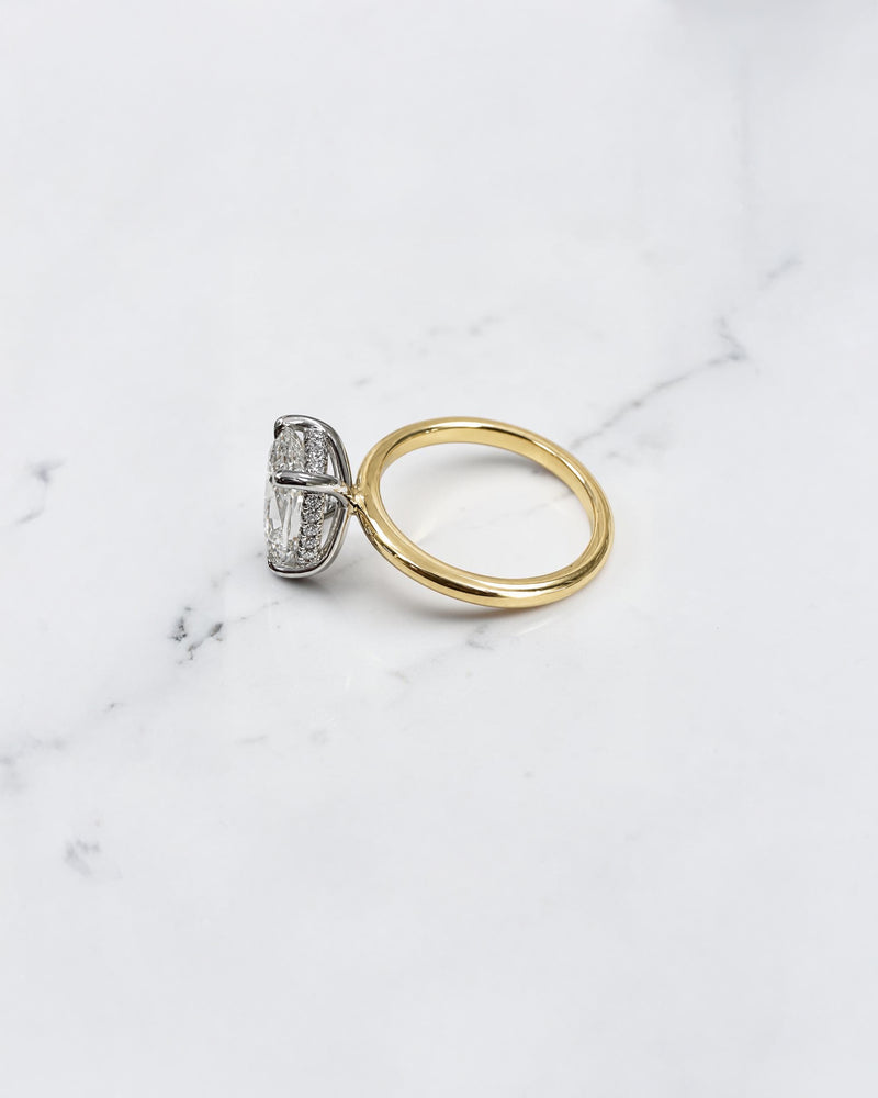 2.90ct old mine cut elongated cushion diamond engagement ring with hidden halo in two tone 18kt yellow gold band and platinum setting