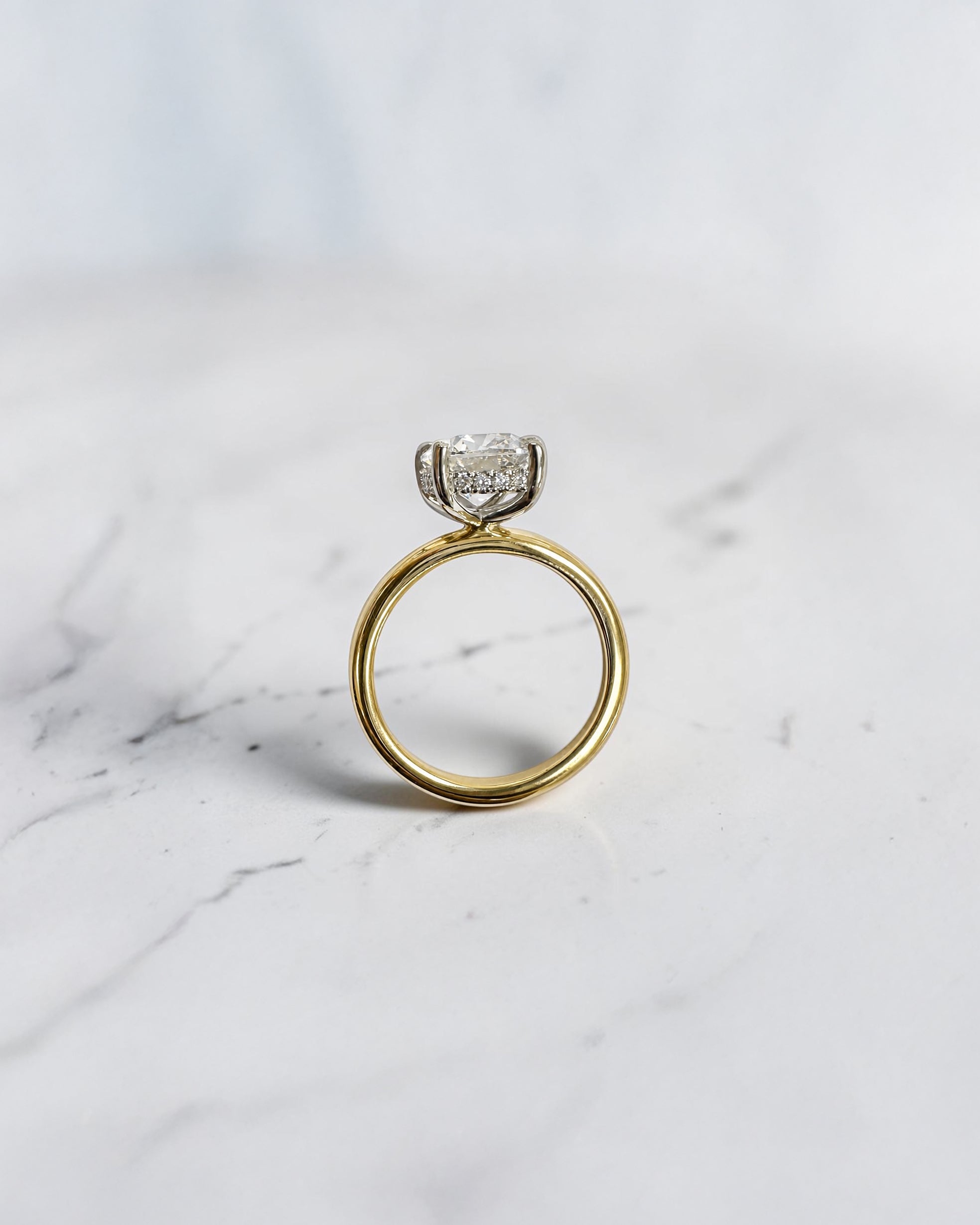 2.90ct old mine cut elongated cushion diamond engagement ring with hidden halo in two tone 18kt yellow gold band and platinum setting