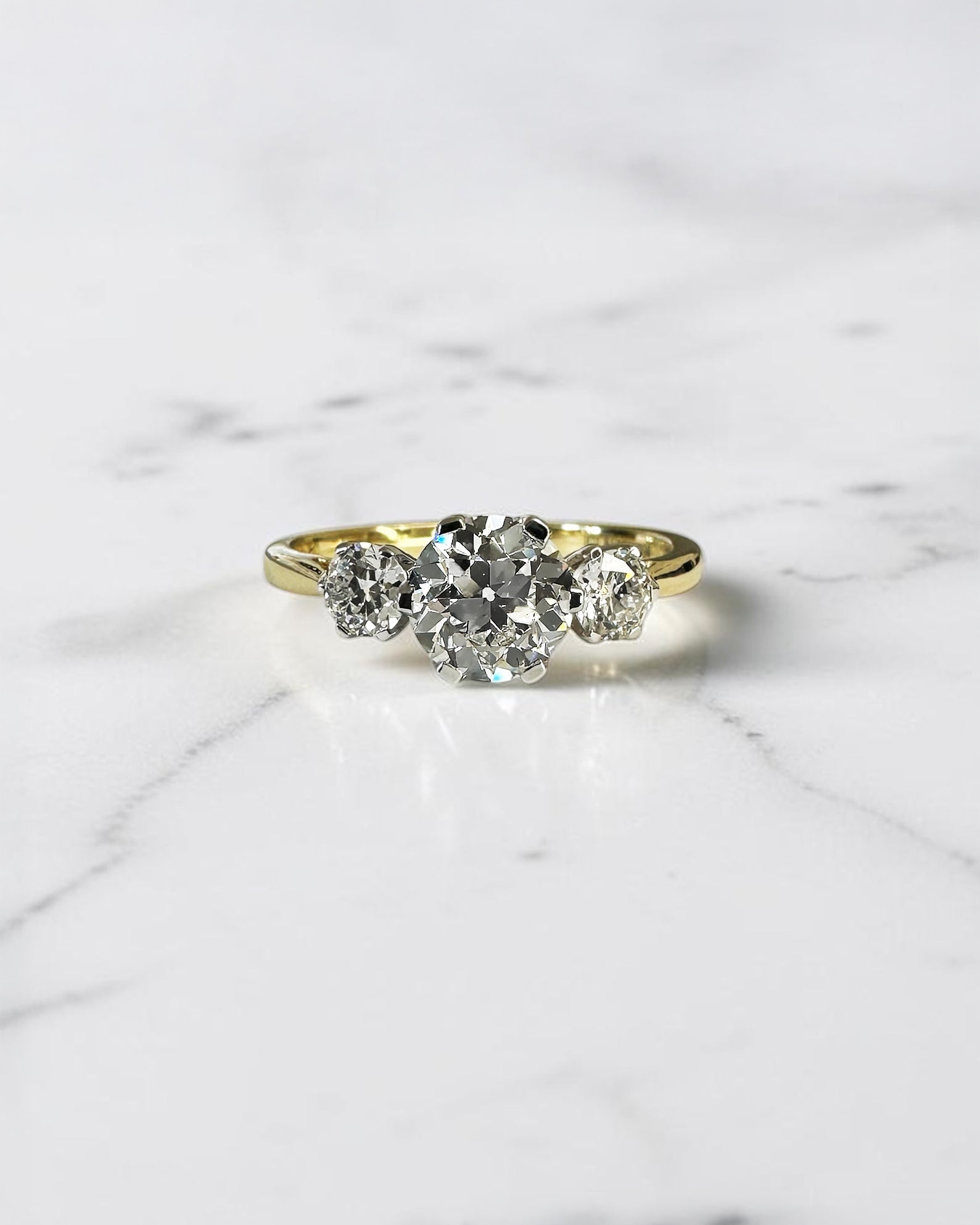 1.40ct Old Mine Cut trilogy diamond engagement ring with 1ct centre diamond, platinum setting and 18ct yellow gold band.