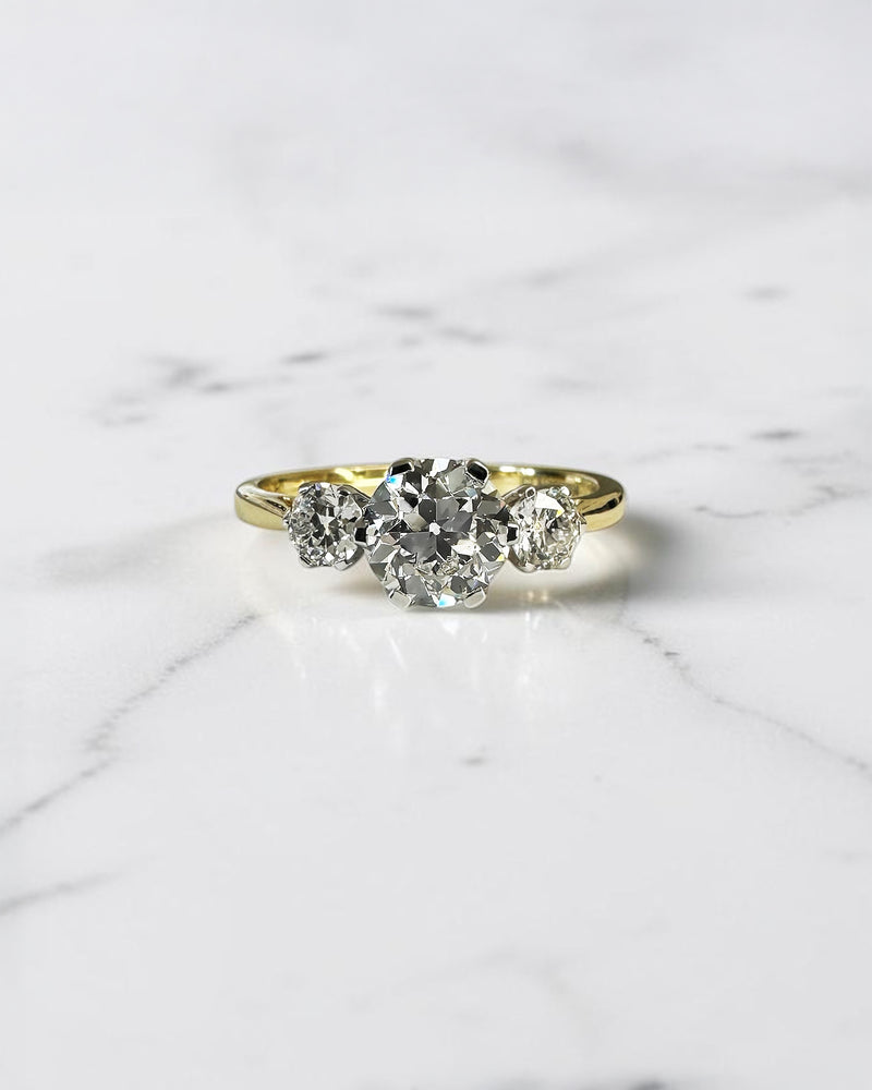 1.40ct Old Mine Cut trilogy diamond engagement ring with 1ct centre diamond, platinum setting and 18ct yellow gold band.