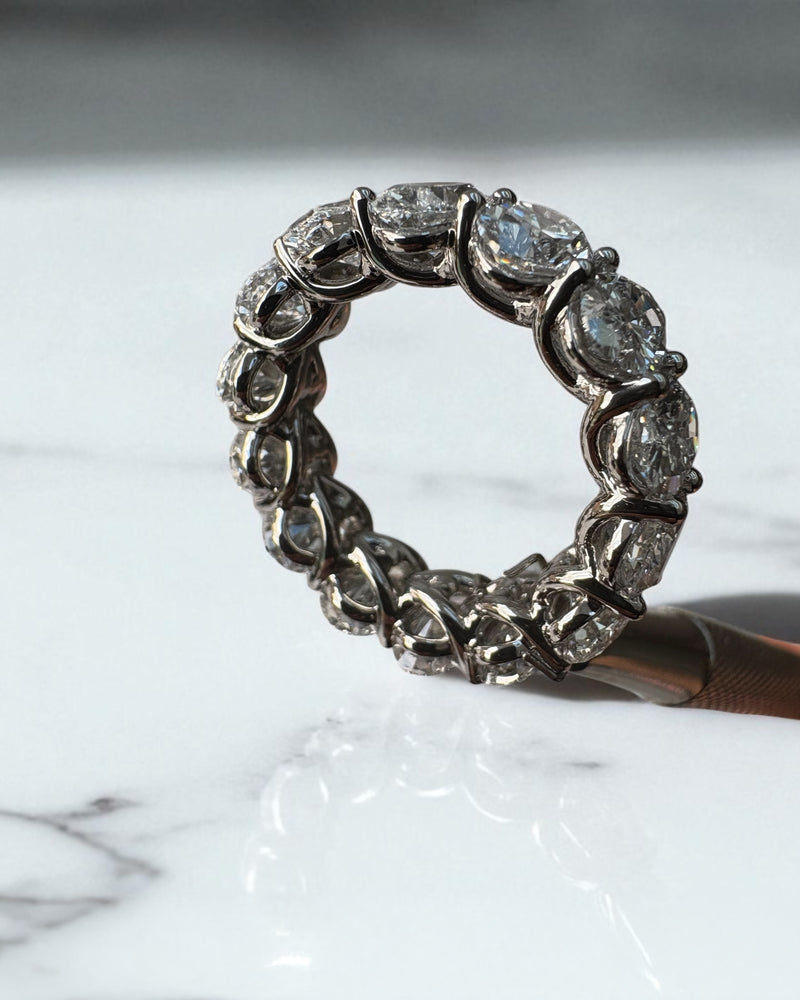 10ct full oval diamond eternity band worn on a finger, showcasing a statement oval diamond engagement rings design.