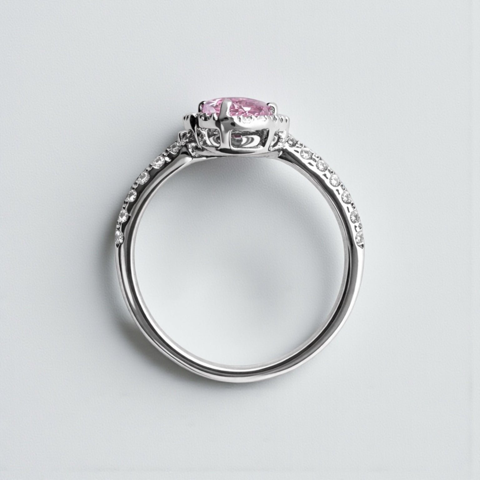 Two stone heart cut pink sapphire and diamond halo ring in platinum