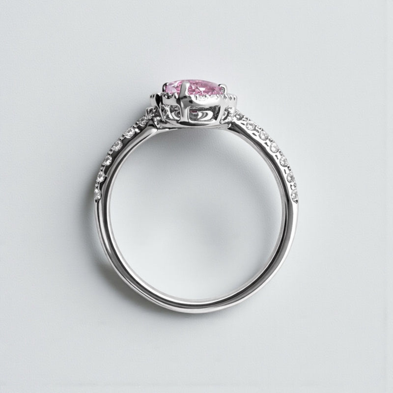 Two stone heart cut pink sapphire and diamond halo ring in platinum