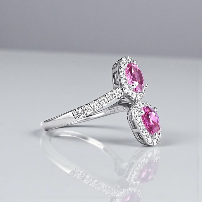 Two stone heart cut pink sapphire and diamond halo ring in platinum