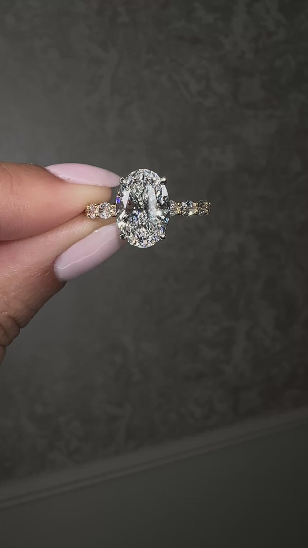 3ct oval cut lab grown diamond hidden halo engagement ring with east west oval diamond band in two tone platinum and 18kt yellow gold.