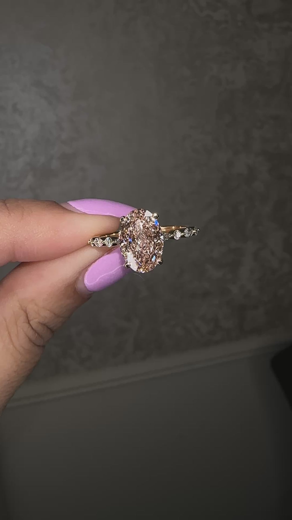 3ct pink oval cut lab grown diamond engagement ring with a floating setting, marquise and round diamond band in 18ct yellow gold, handcrafted in London by Layla Diamonds.