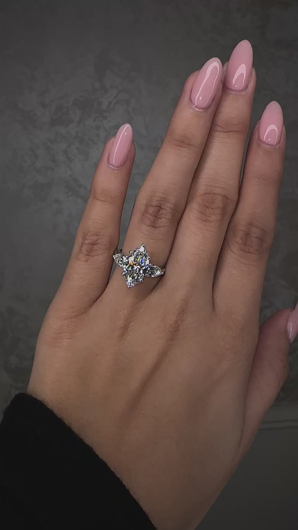3ct marquise cut lab grown diamond trilogy ring with pear side stones, total 3.80ct, worn on hand in 18kt white gold