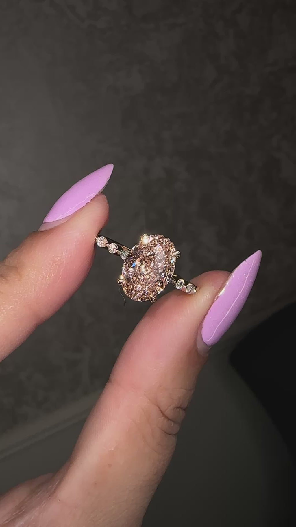 3ct pink oval cut lab grown diamond engagement ring with a floating setting, marquise and round diamond band in 18ct yellow gold, handcrafted in London by Layla Diamonds.