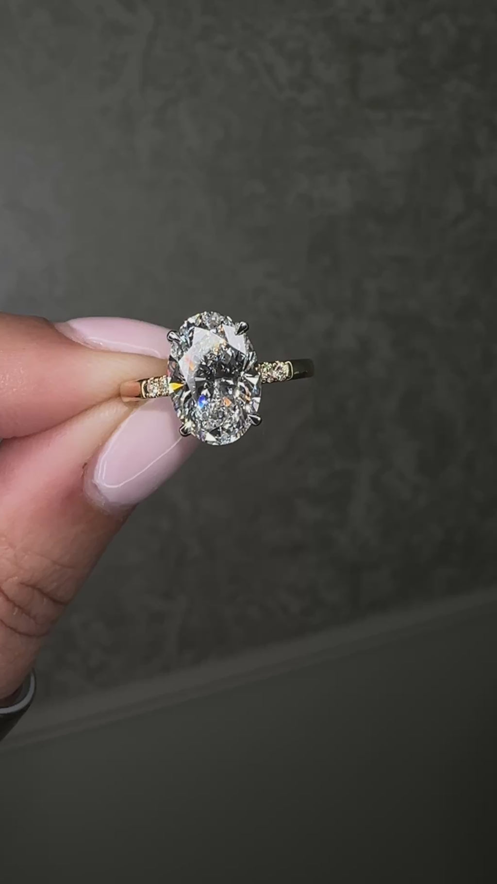 3ct oval cut lab grown diamond engagement ring with a cathedral setting, partial pavé diamond band and diamond wrap around hidden halo. Handmade in London and available in platinum or 18kt yellow gold.
