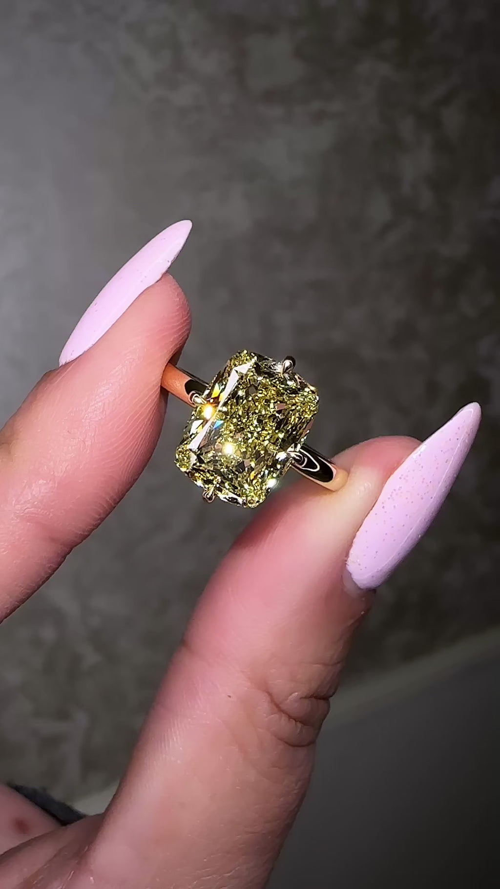 A stunning 5ct Fancy Intense Yellow elongated cushion cut diamond solitaire with platinum hidden halo and 18kt yellow gold band engagement ring. Bold, elegant and handcrafted in London.