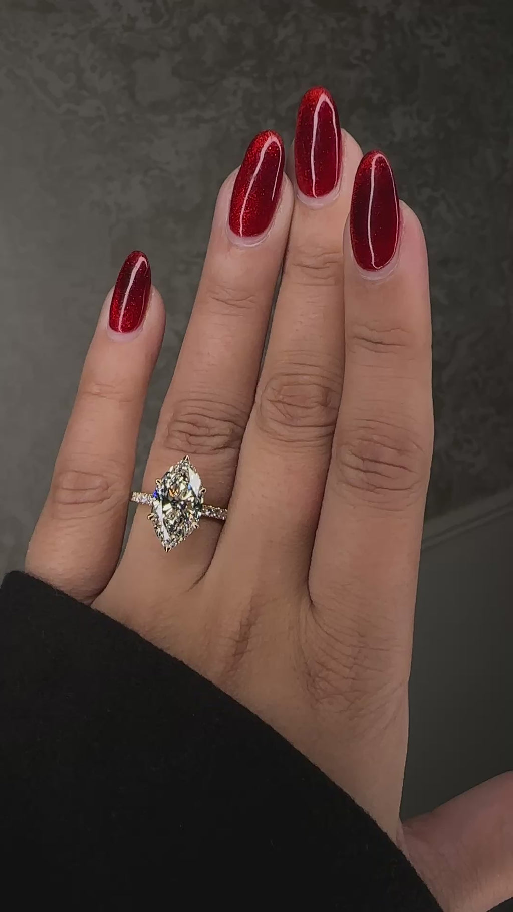 5ct marquise cut lab grown diamond engagement ring with hidden halo and diamond shoulders in floating setting on hand