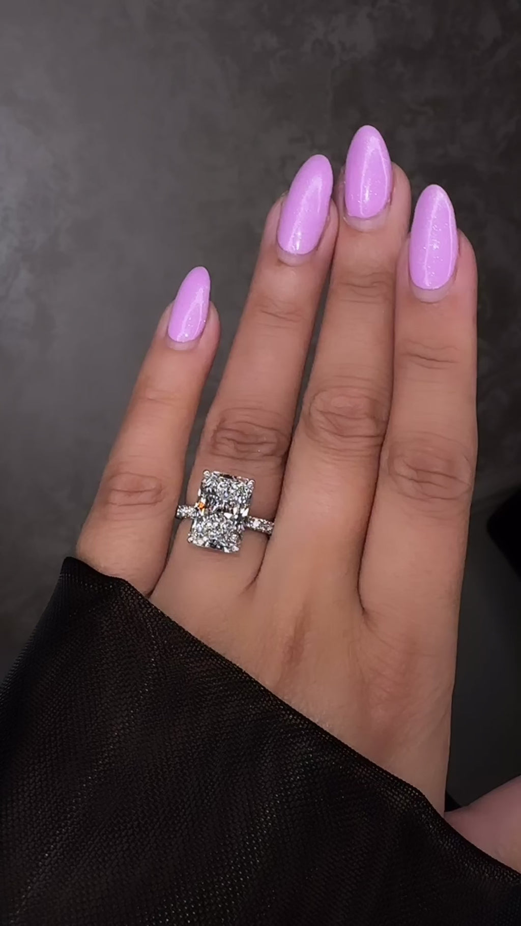 7ct radiant cut lab grown diamond engagement ring on hand with diamond shoulder band, floating setting and wrap around hidden halo, handmade in London.