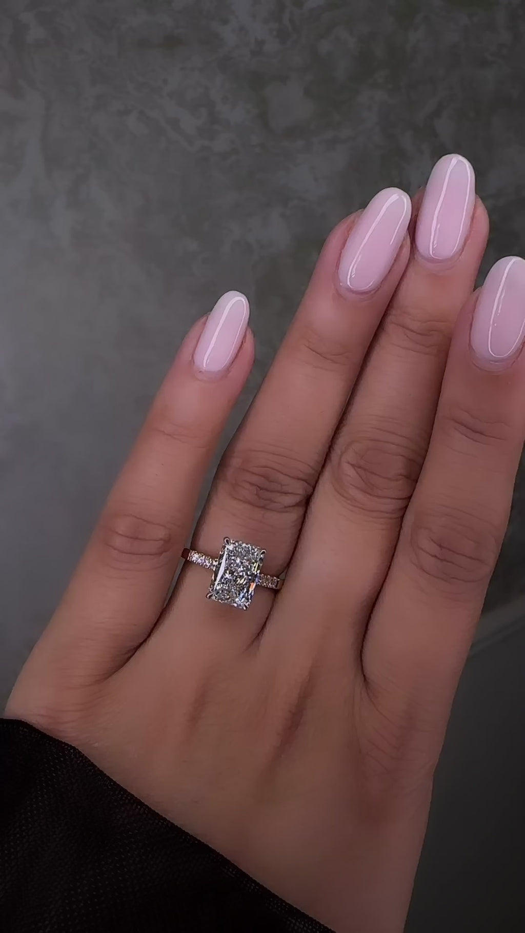 3ct radiant cut lab grown diamond engagement ring with partial pavé band, cathedral setting, hidden halo and two tone yellow gold band on hand