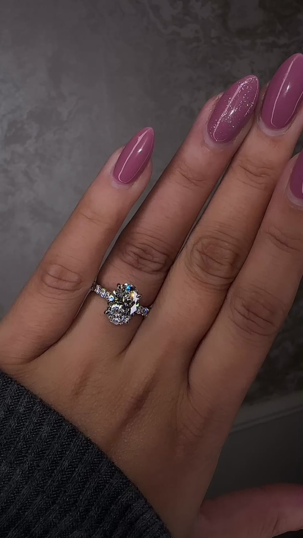3ct oval cut lab grown diamond u prong setting, cathedral engagement ring in platinum on hand