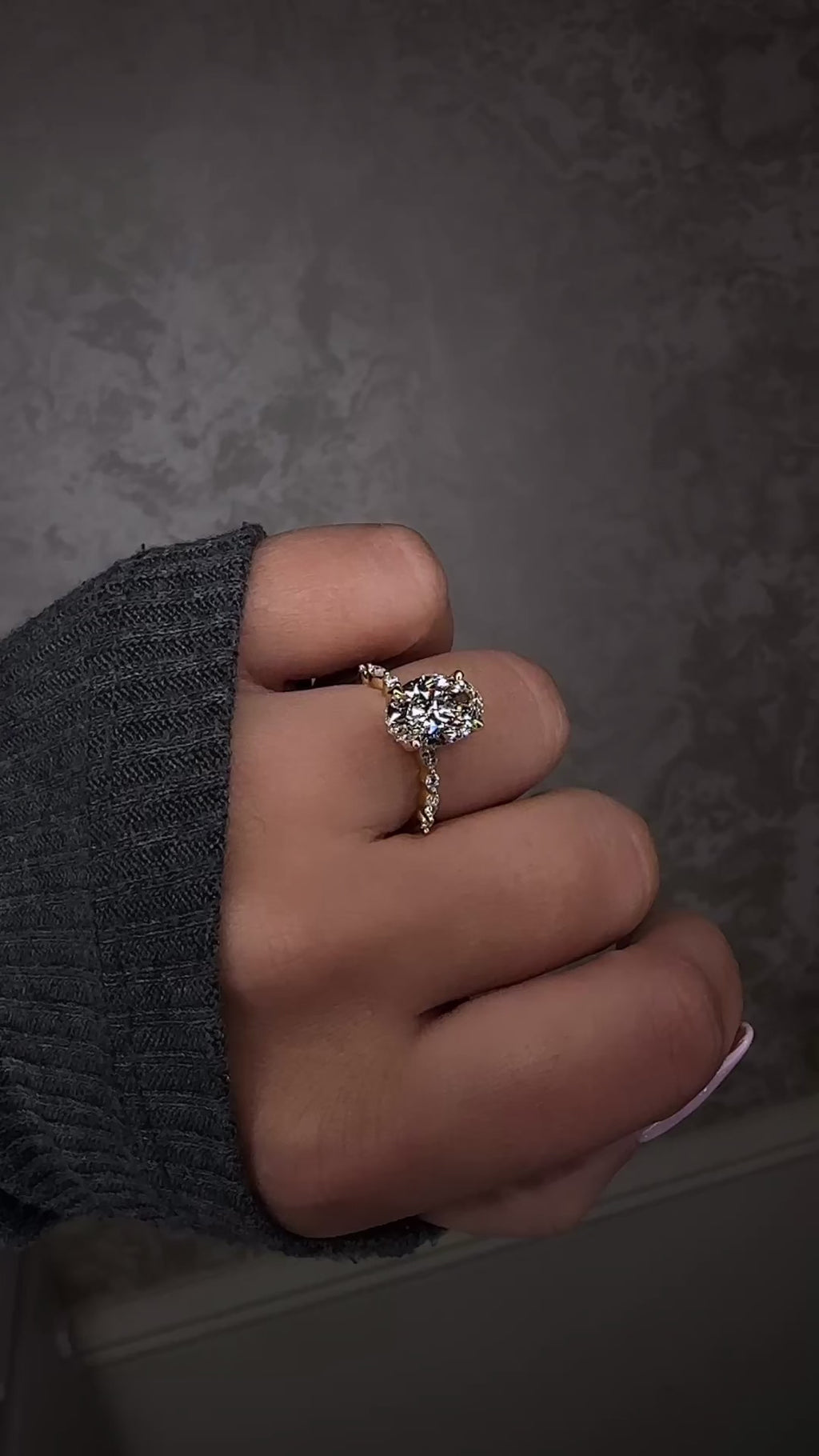 Oval 3ct lab grown diamond ring featuring marquise and round diamond band and delicate hidden halo 18kt yellow gold on hand