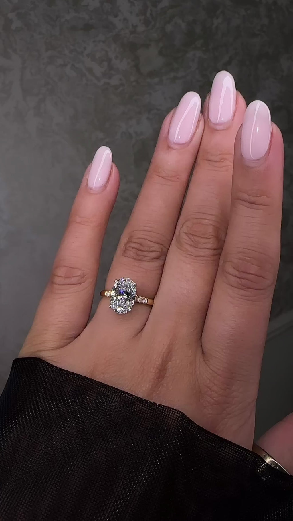 3ct oval cut lab grown diamond engagement ring with a cathedral setting, partial pavé diamond band and diamond wrap around hidden halo. Handmade in London and available in platinum or 18kt yellow gold.
