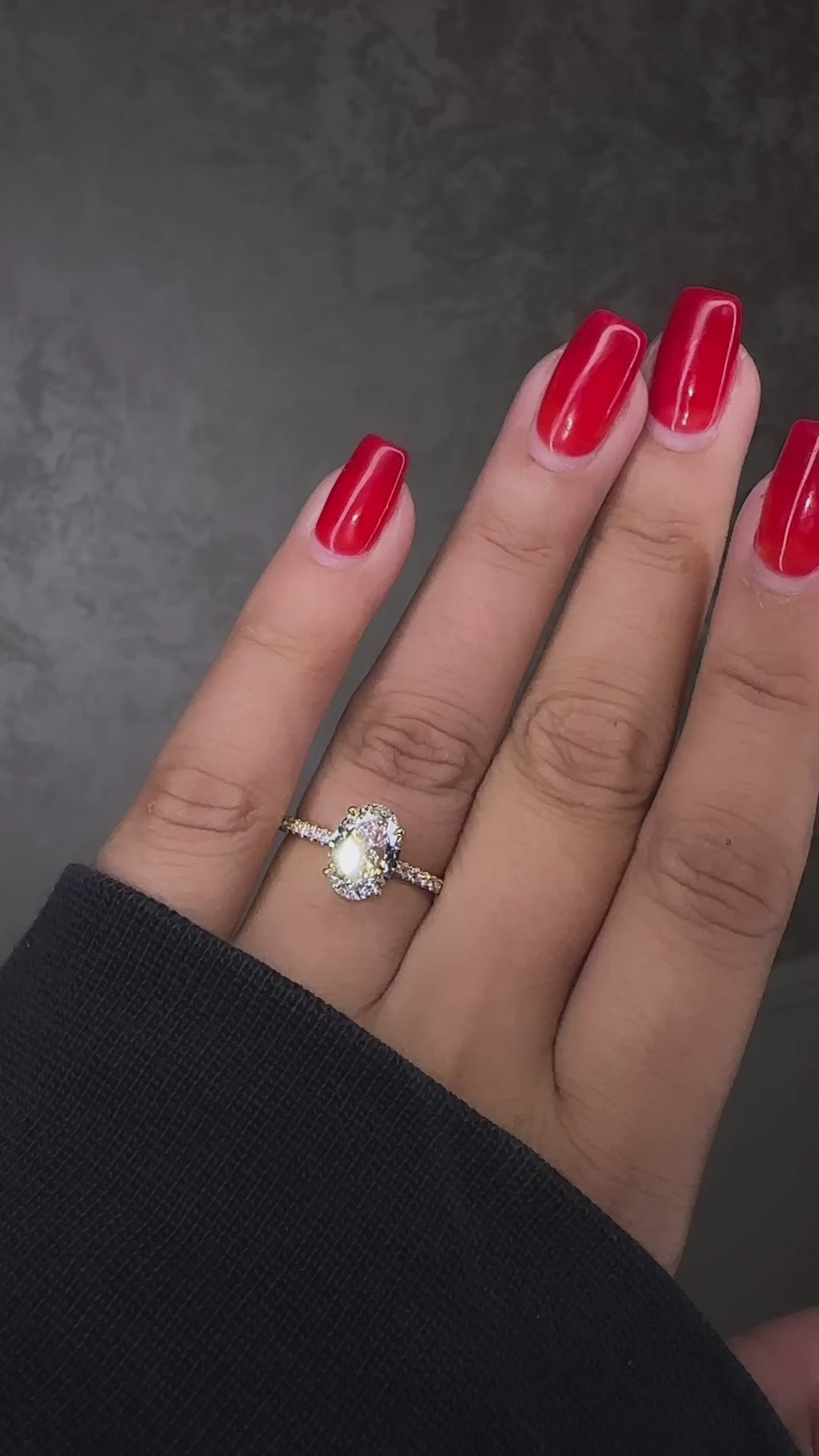 2ct oval cut lab grown diamond hidden halo diamond shoulders 18kt yellow gold on hand 