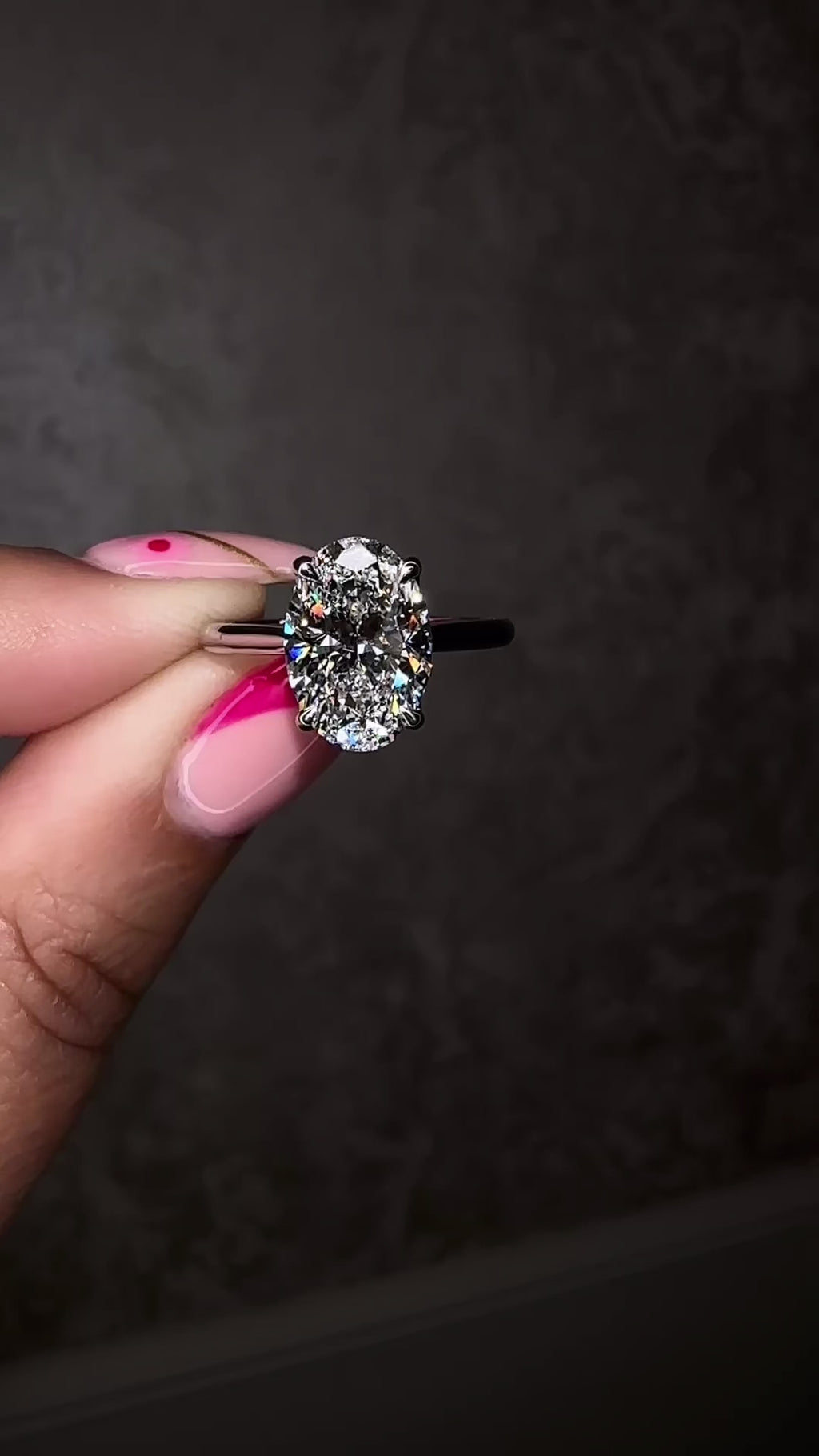 Platinum 3ct oval cut diamond solitaire engagement ring on hand with lotus head and diamond bridge — handcrafted by Layla Diamonds London
