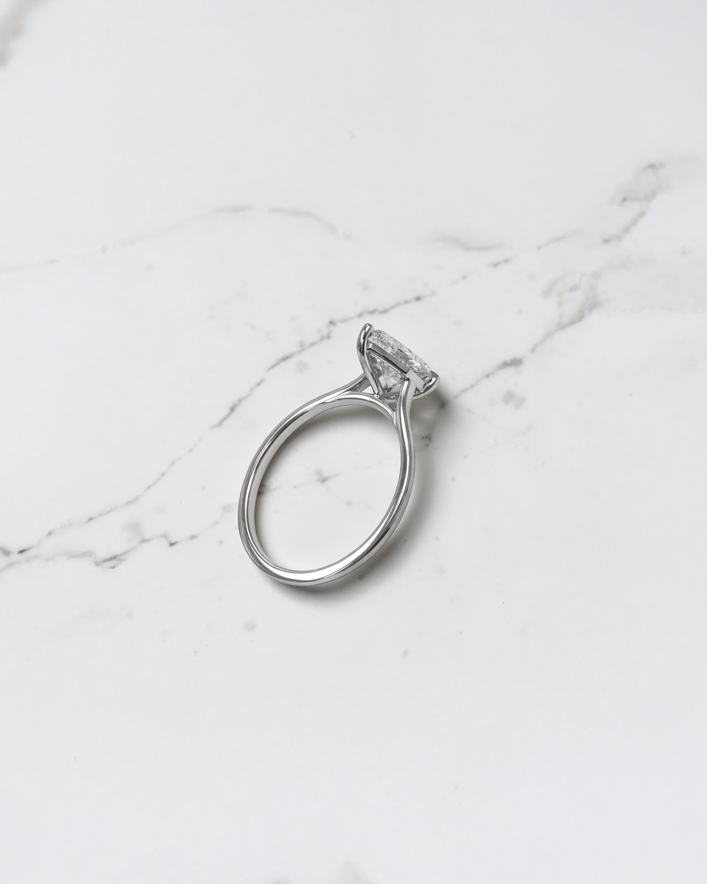 2ct pear cut lab grown diamond cathedral solitaire engagement ring with a plain band in platinum or 18kt gold, elegant and timeless design