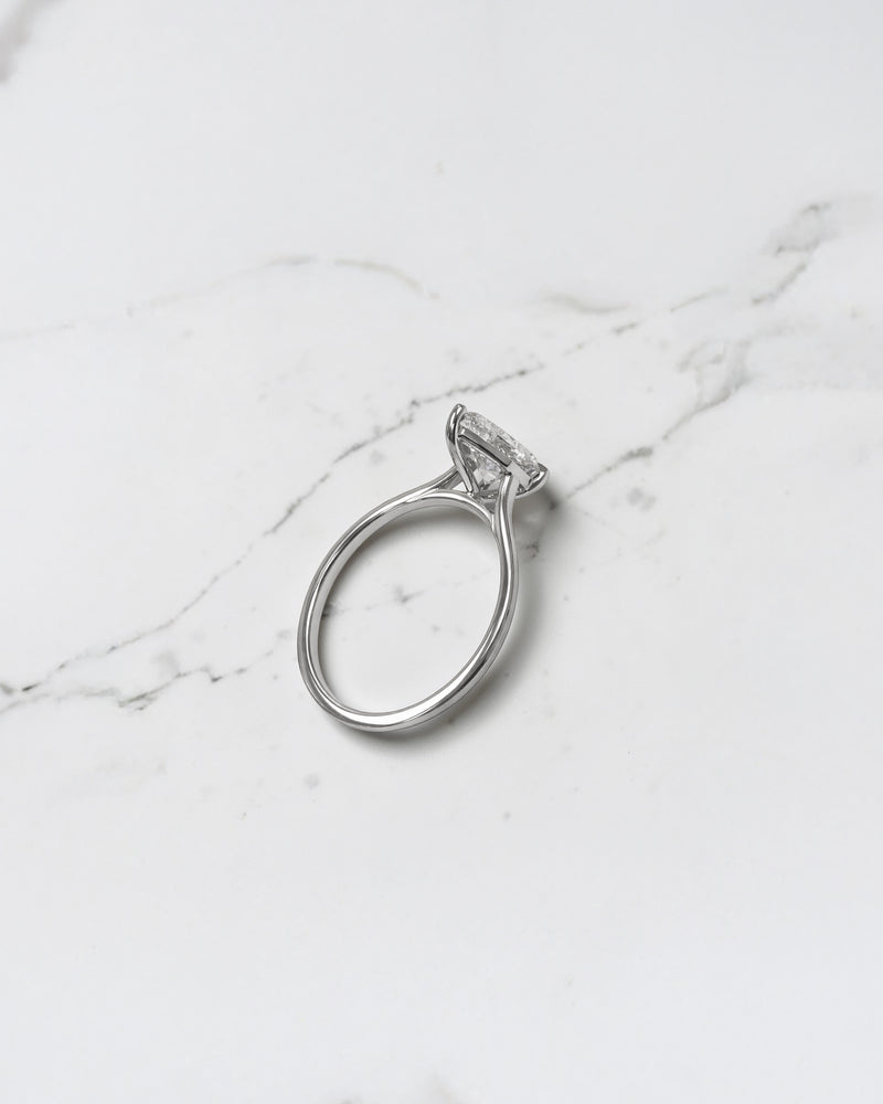 2ct pear cut lab grown diamond cathedral solitaire engagement ring with a plain band in platinum or 18kt gold, elegant and timeless design
