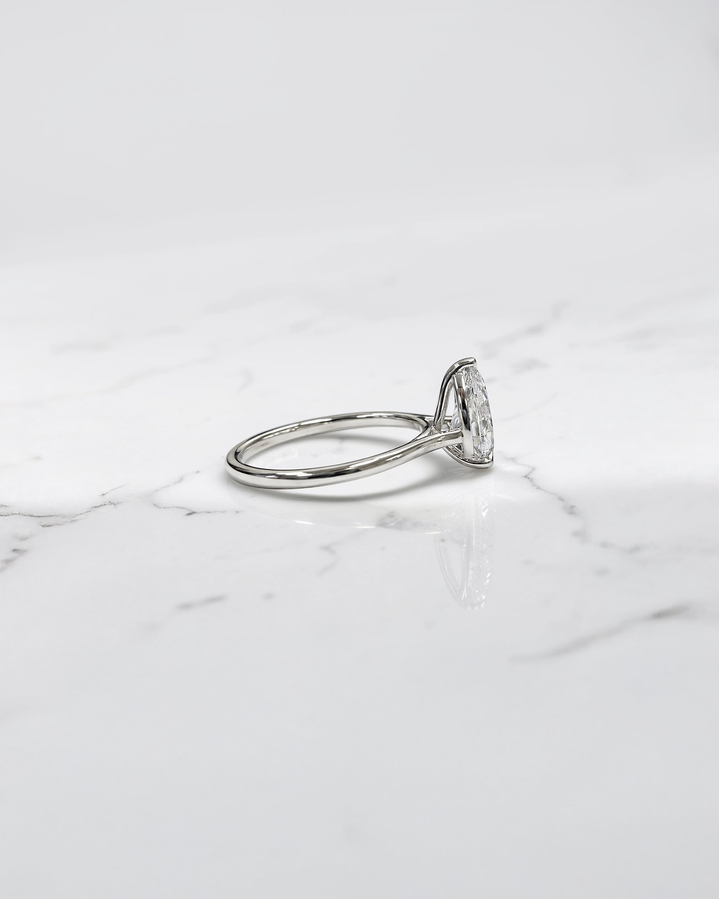 2ct pear cut lab grown diamond cathedral solitaire engagement ring with a plain band in platinum or 18kt gold, elegant and timeless design