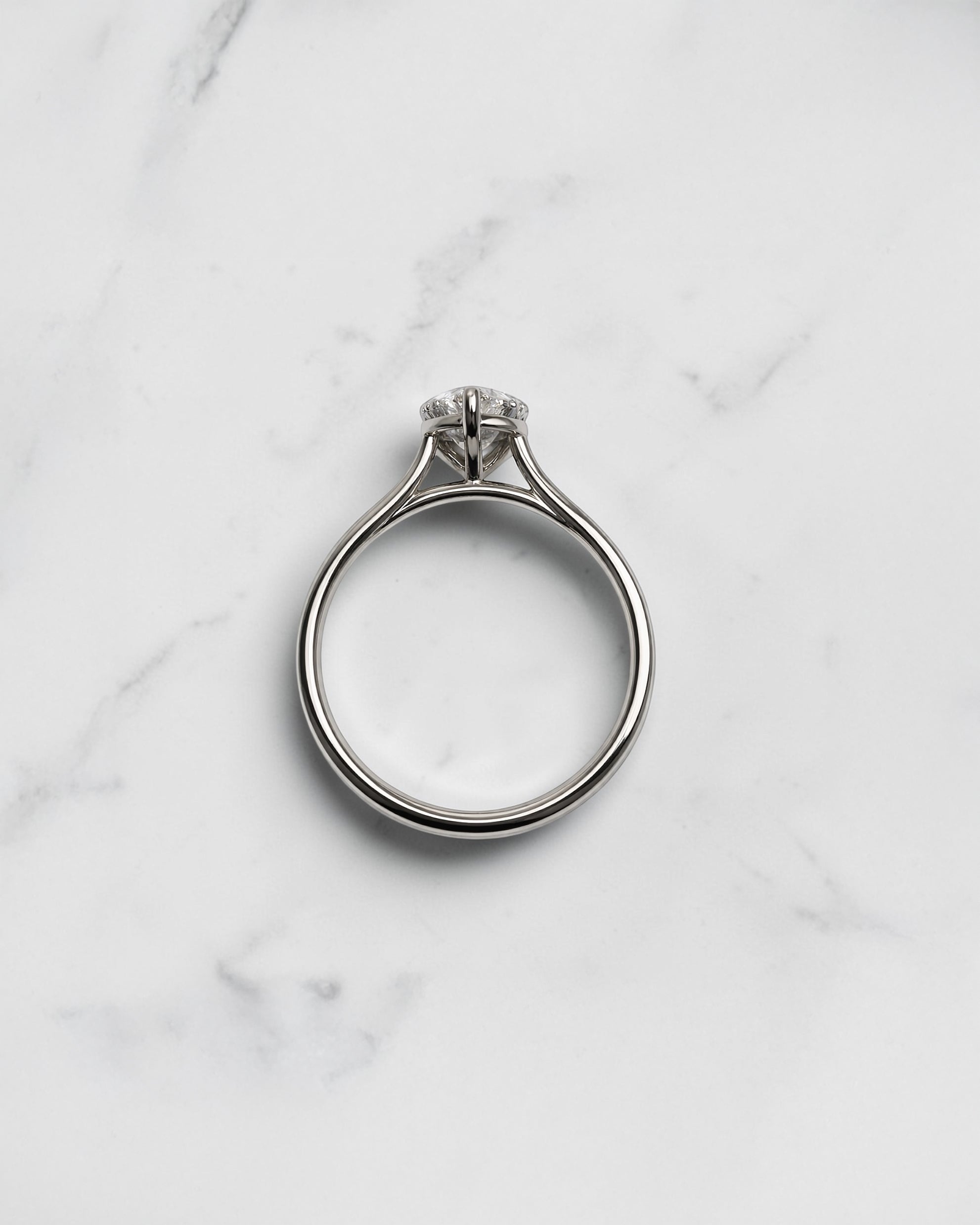 2ct pear cut lab grown diamond cathedral solitaire engagement ring with a plain band in platinum or 18kt gold, elegant and timeless design