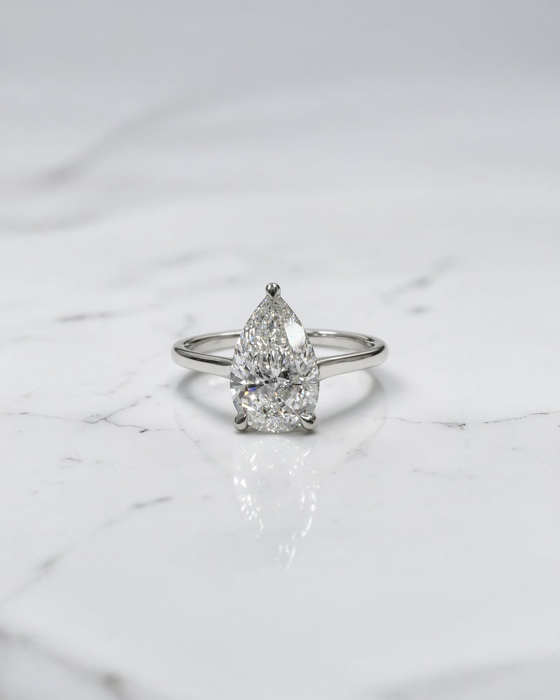 2ct pear cut lab grown diamond cathedral solitaire engagement ring with a plain band in platinum or 18kt gold, elegant and timeless design