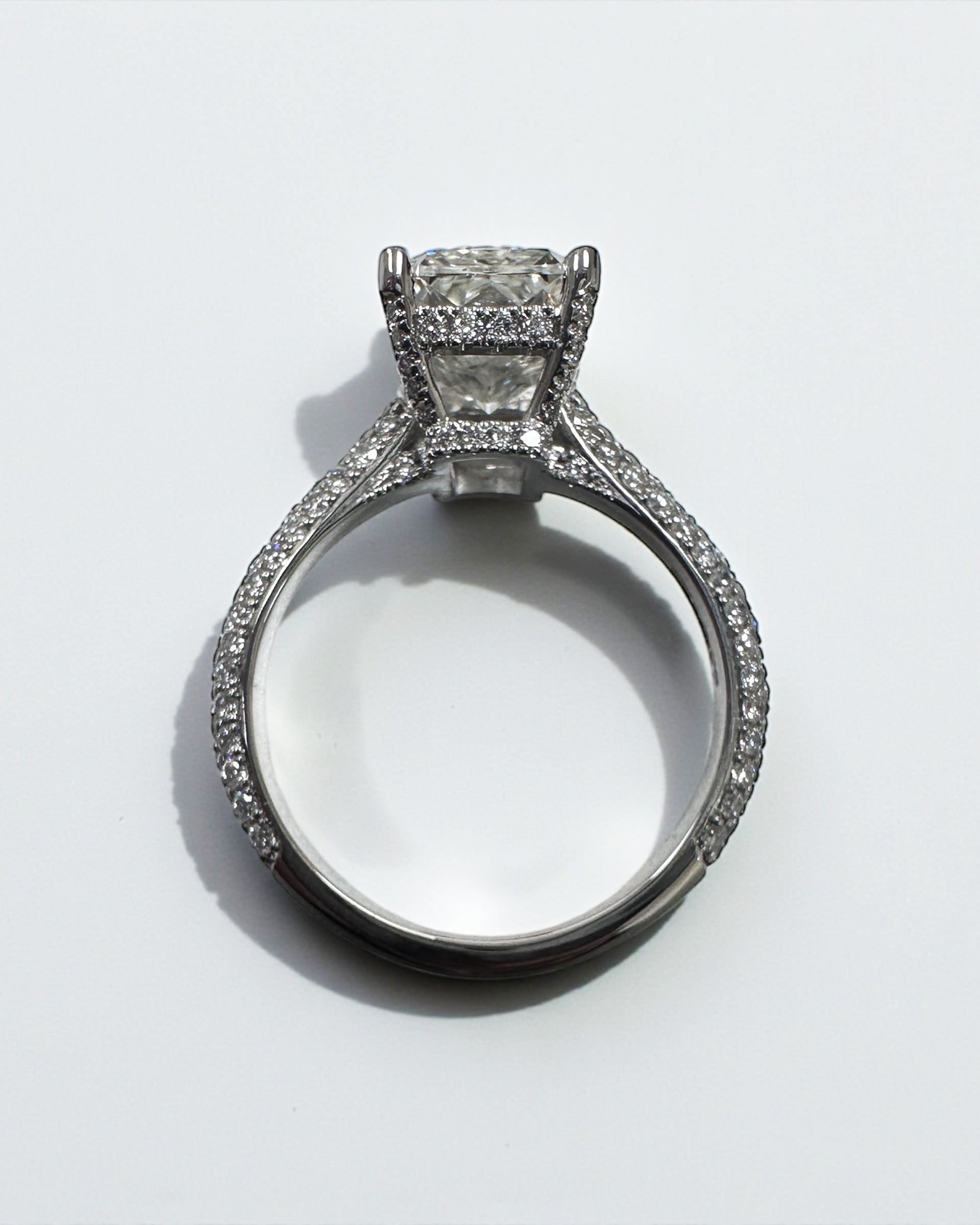 3ct radiant cut lab grown diamond set in a three row diamond band 3D cathedral style with hidden halo, platinum or 18kt yellow gold