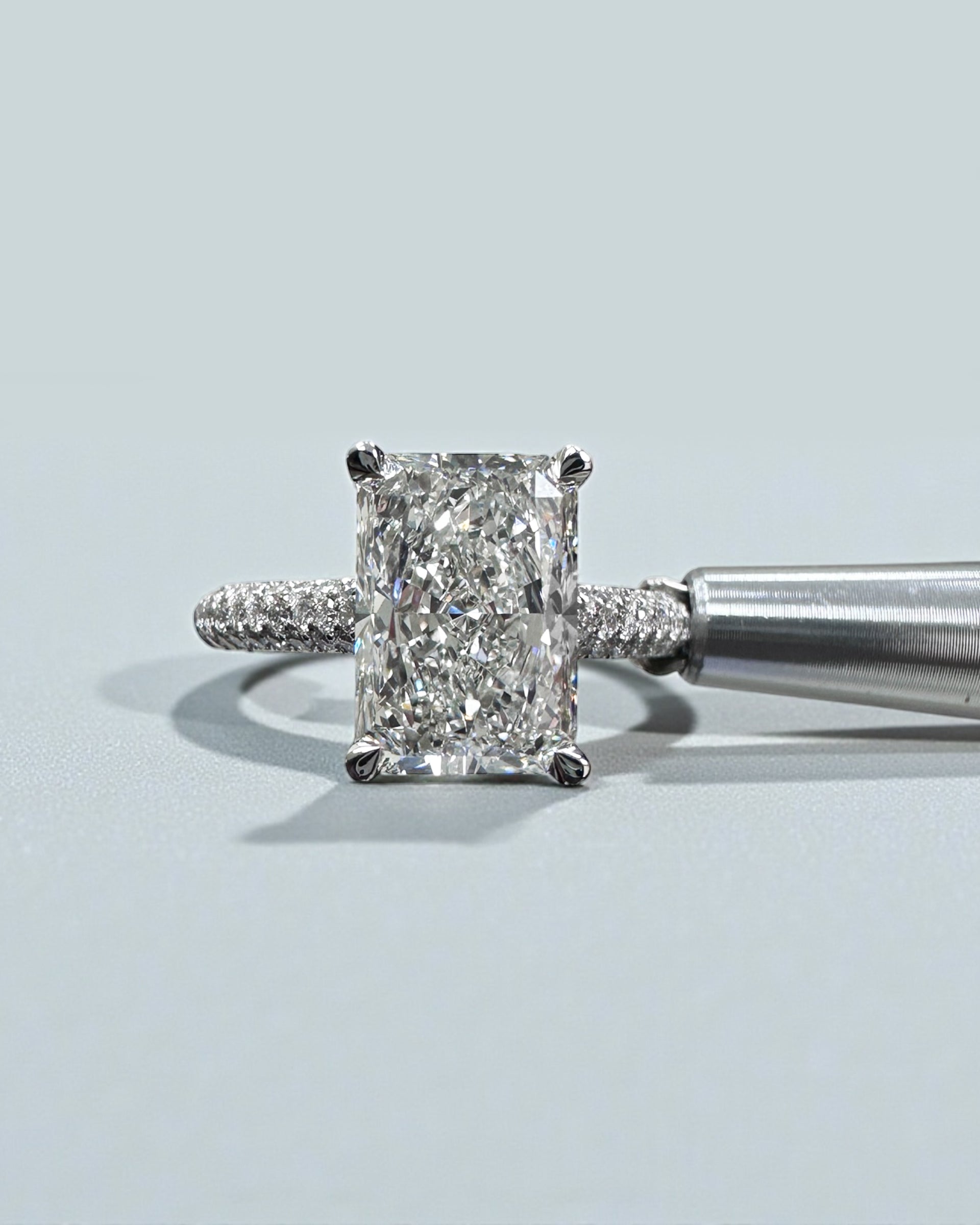 3ct radiant cut lab grown diamond set in a three row diamond band 3D cathedral style with hidden halo, platinum or 18kt yellow gold