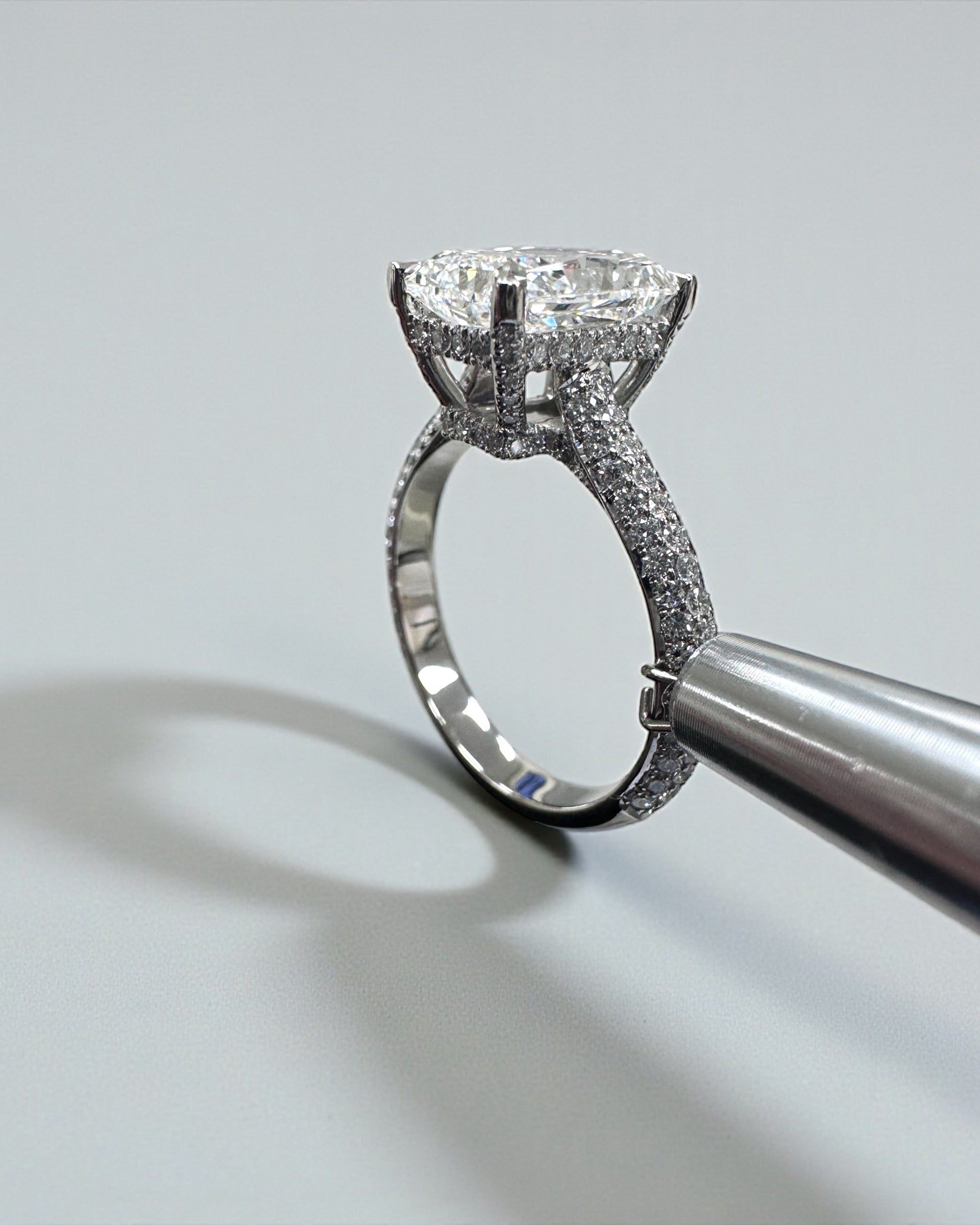 3ct radiant cut lab grown diamond set in a three row diamond band 3D cathedral style with hidden halo, platinum or 18kt yellow gold