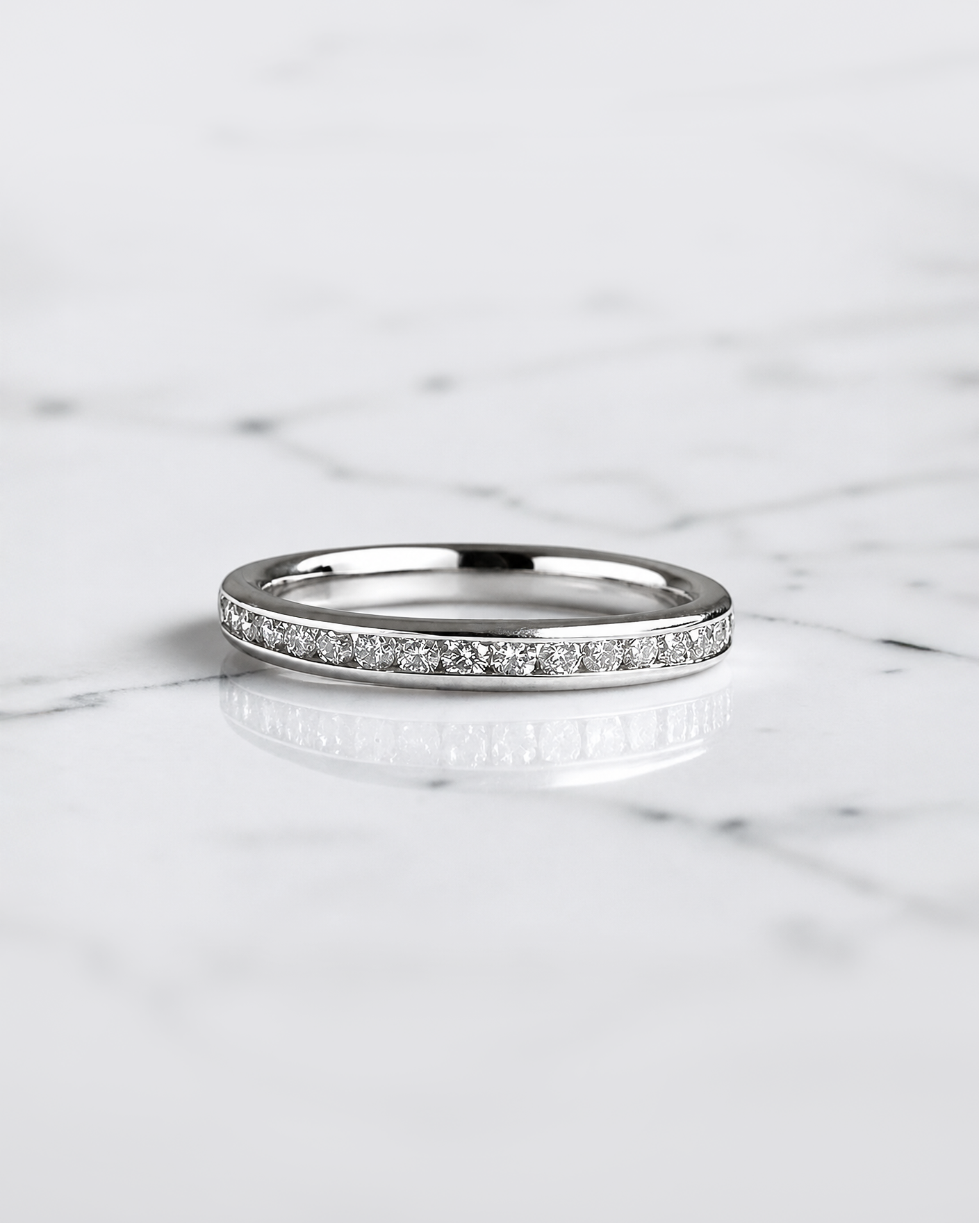 Half set channel set round brilliant diamond wedding band in 18ct yellow gold, white gold or platinum, available with lab grown or natural diamonds.