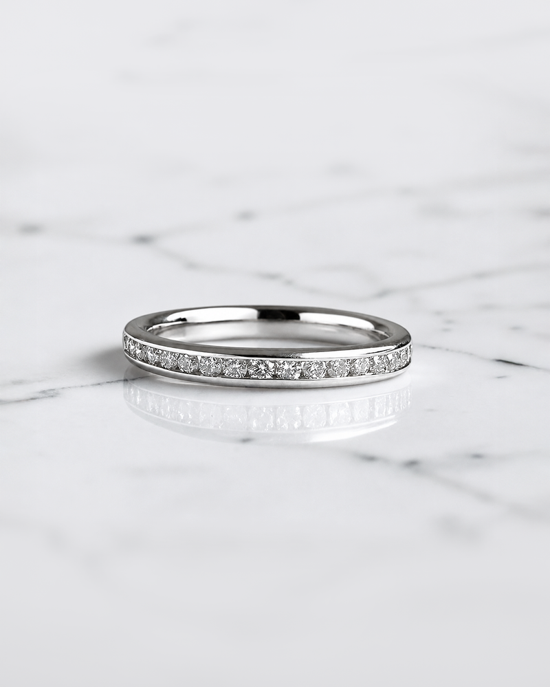 Half set channel set round brilliant diamond wedding band in 18ct yellow gold, white gold or platinum, available with lab grown or natural diamonds.